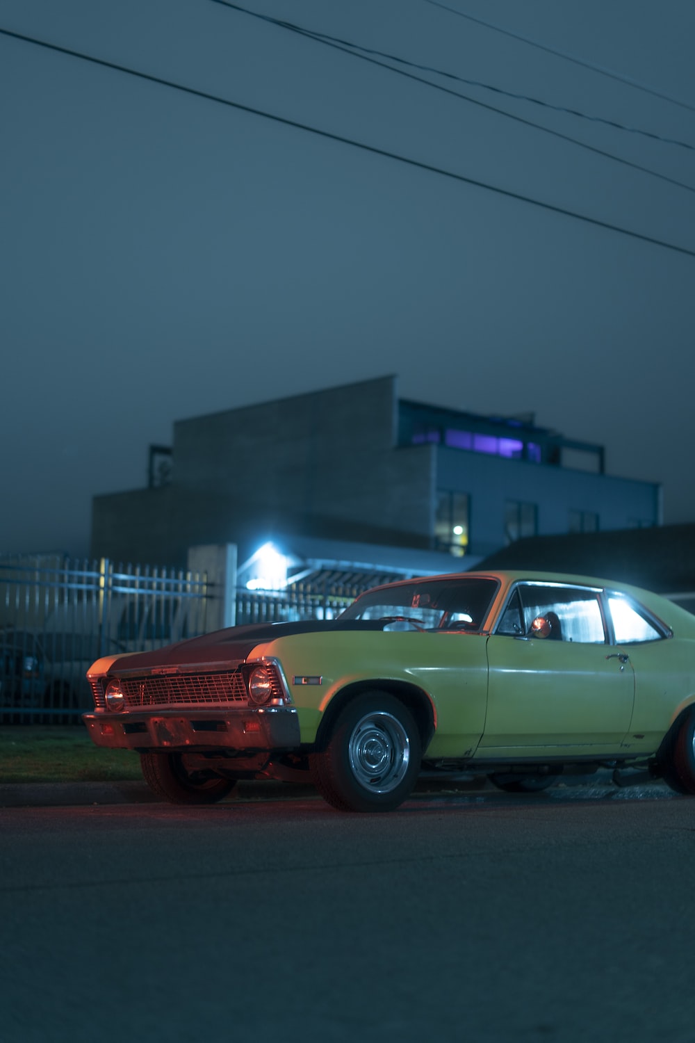 White and red vintage car on road during night time photo
