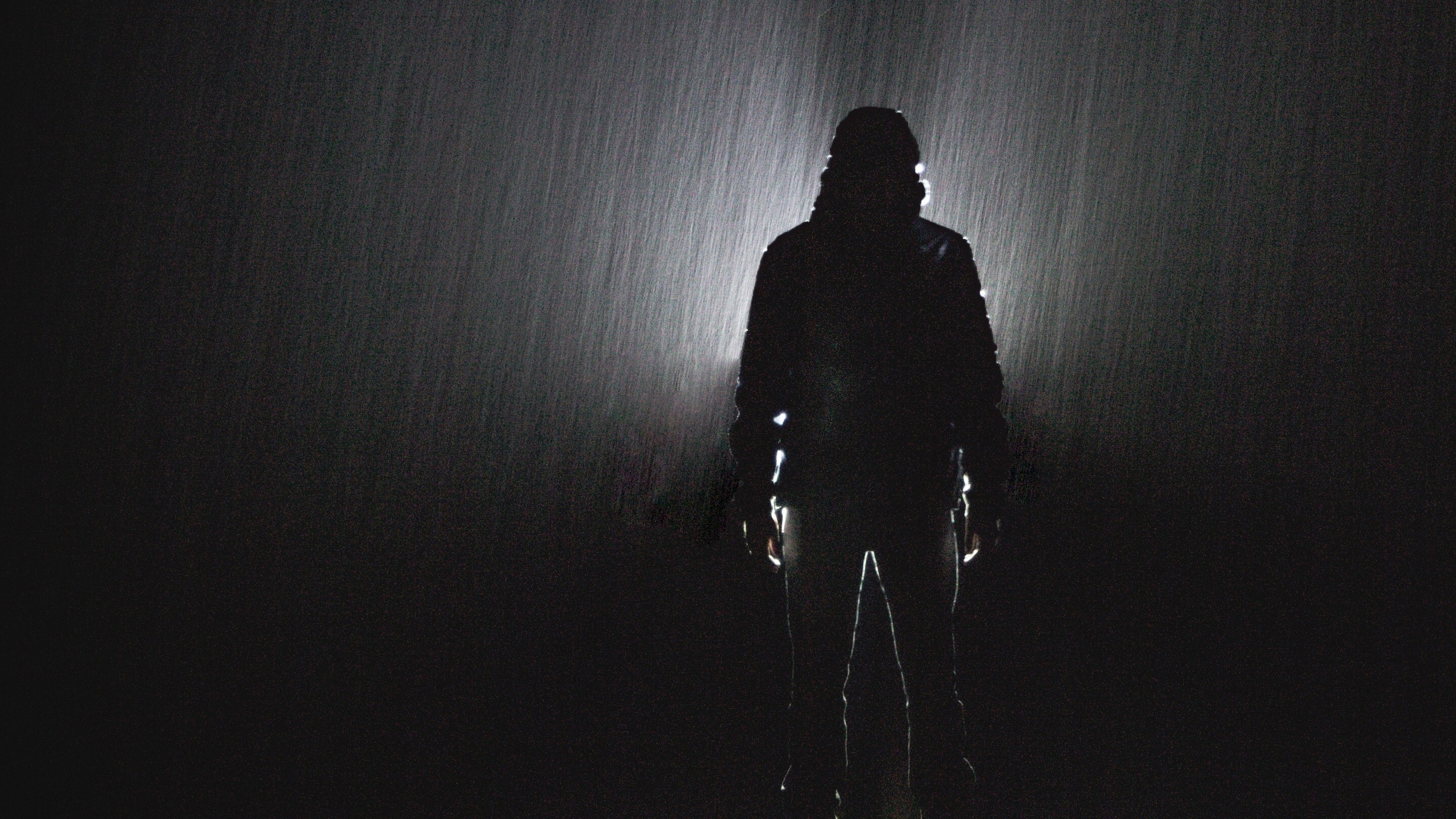 Shadow of Man at Night During Rain Photo