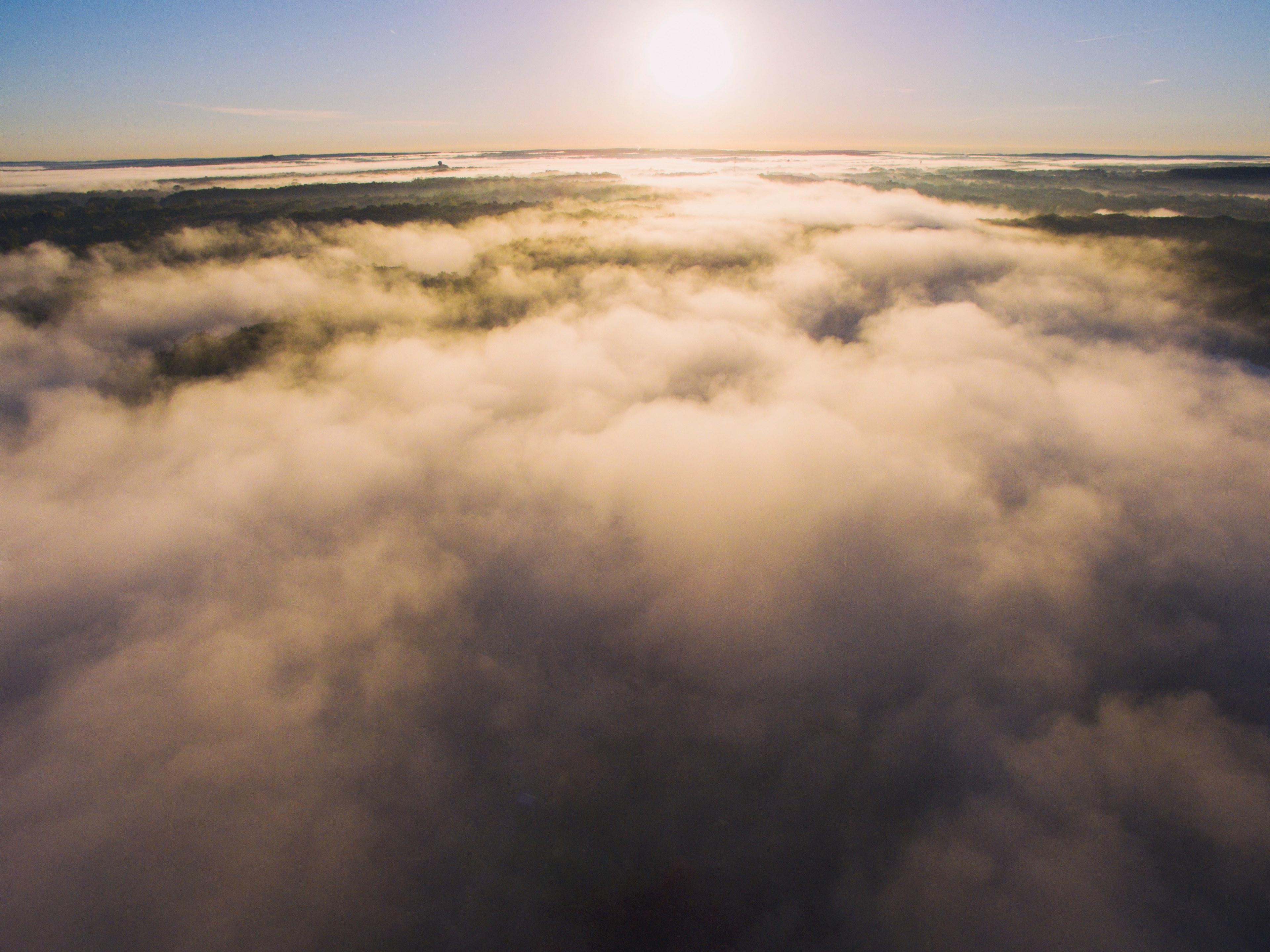 Wallpaper / billowing clouds below a bright sunny sky, above the clouds 4k wallpaper free download