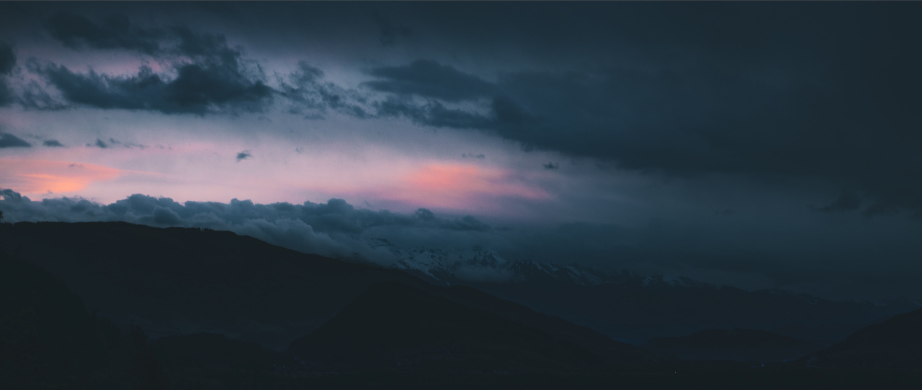 Wallpaper / dark clouds roll over silhouettes of hills at sunset, cloudscape at night 4k wallpaper free download