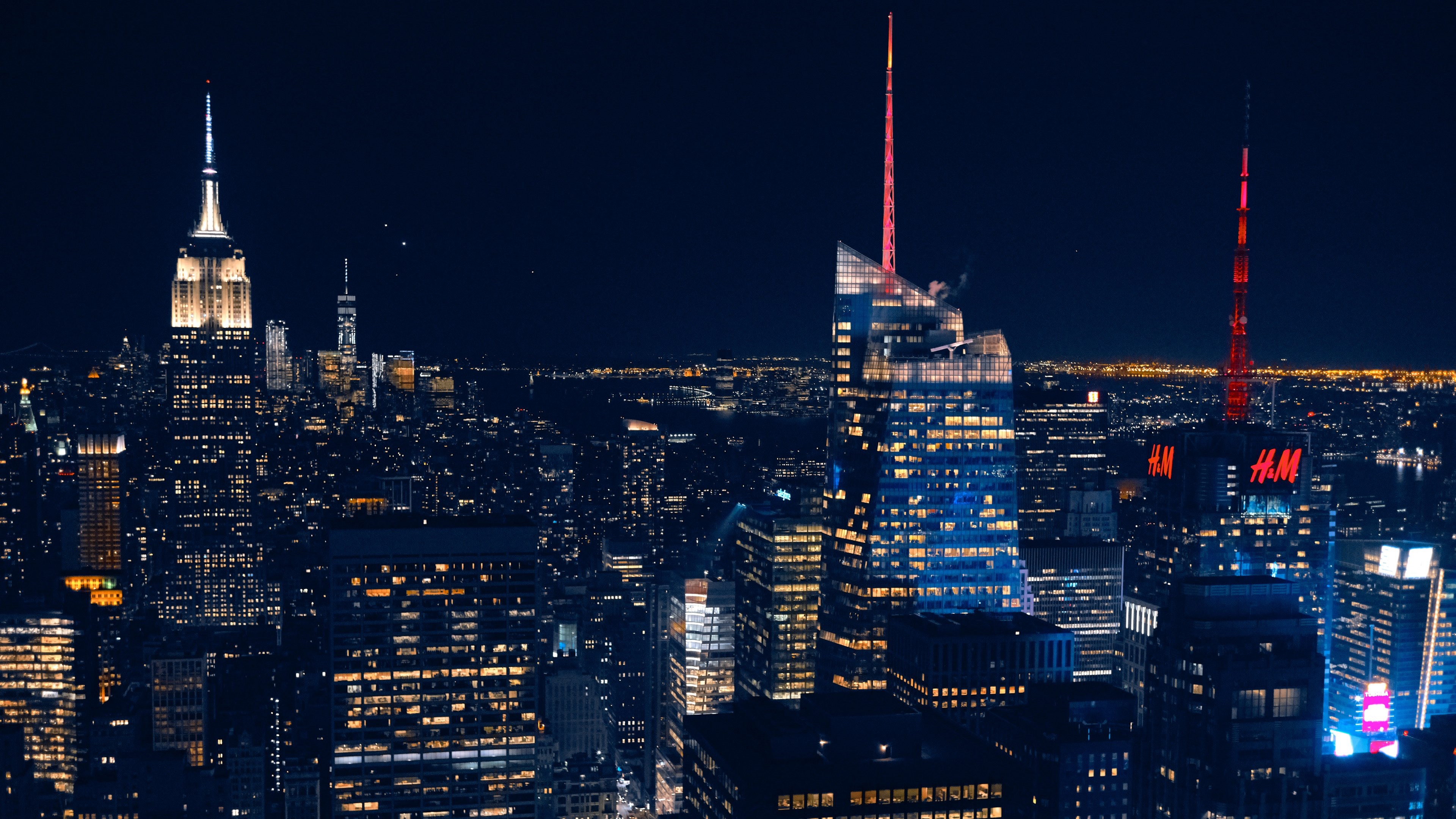 Wallpaper / the new york city skyline and skyscraper lights in the dead of night, city of lights 4k wallpaper free download