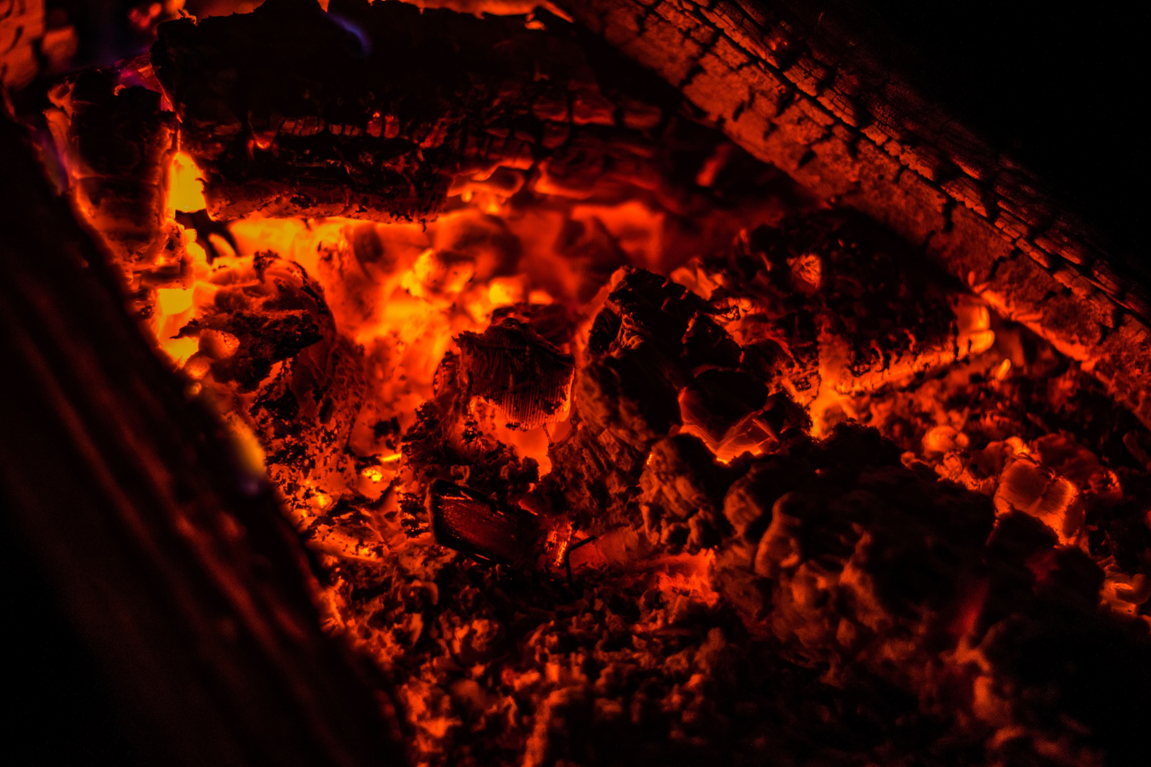 Wallpaper / glowing embers on hot logs in a fireplace, glowing embers 4k wallpaper free download