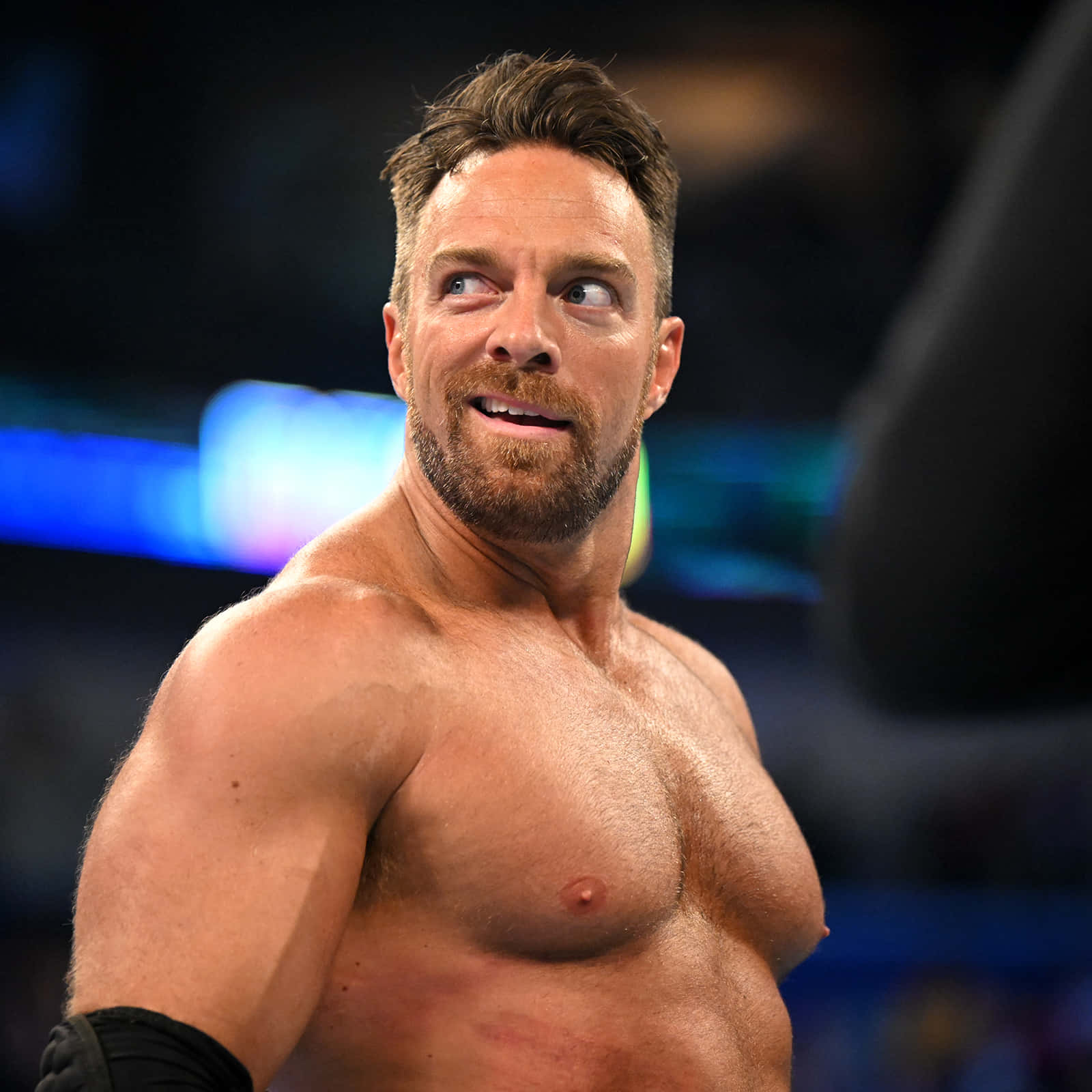 Download La Knight in Action with a confident smirk at WWE event. Wallpaper