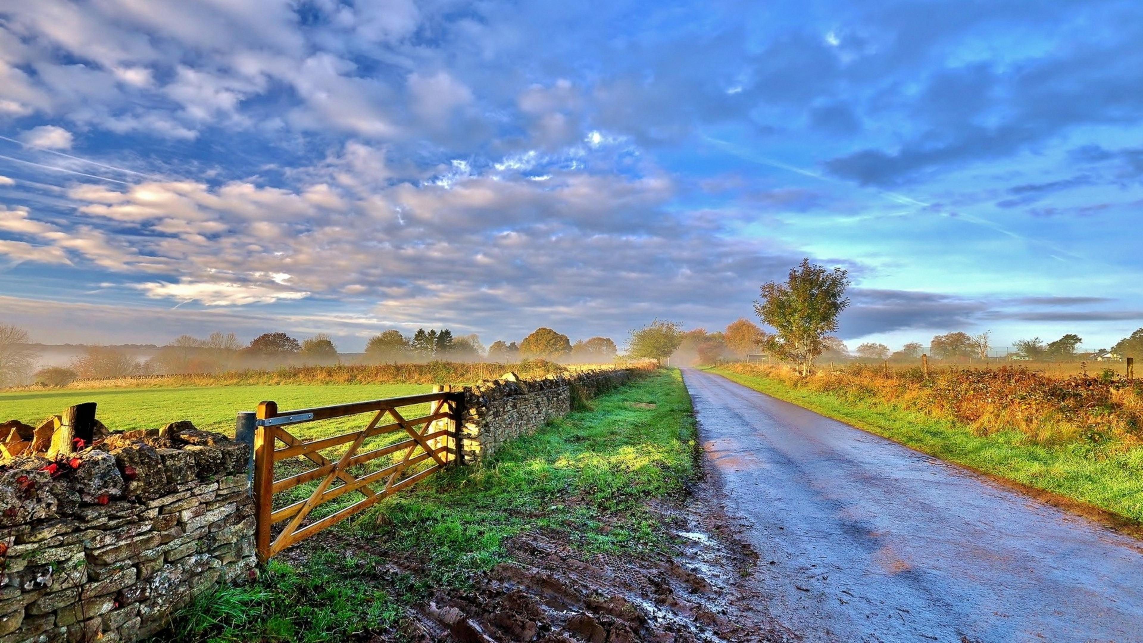 Sunrise over the country side road and fence