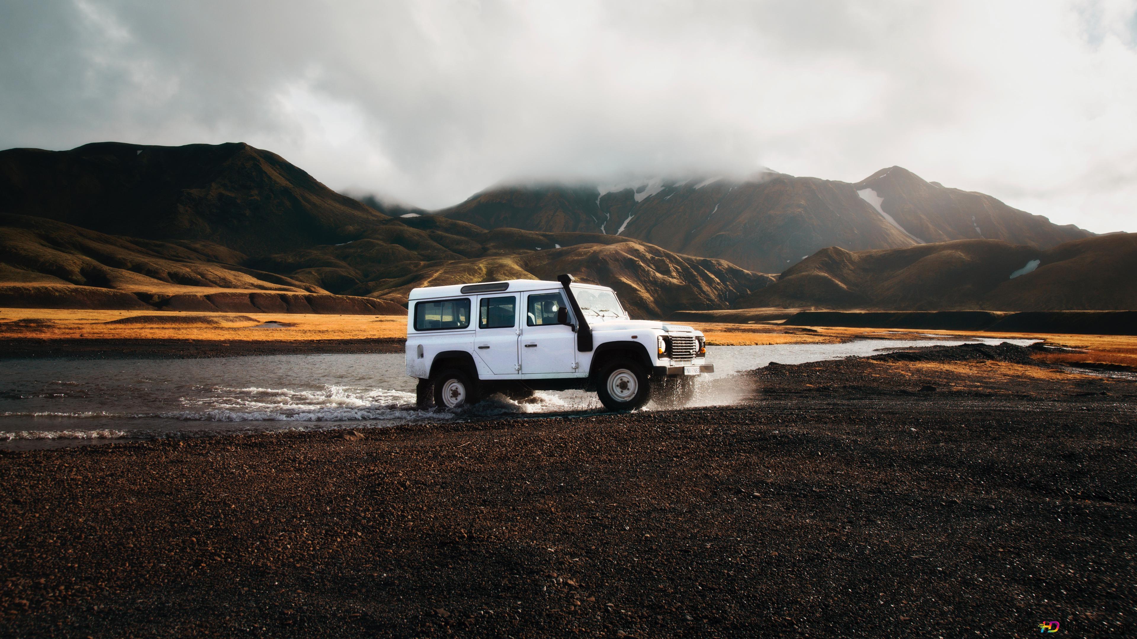 White Land Rover 4X4 in a river with mountains background 4K wallpaper download