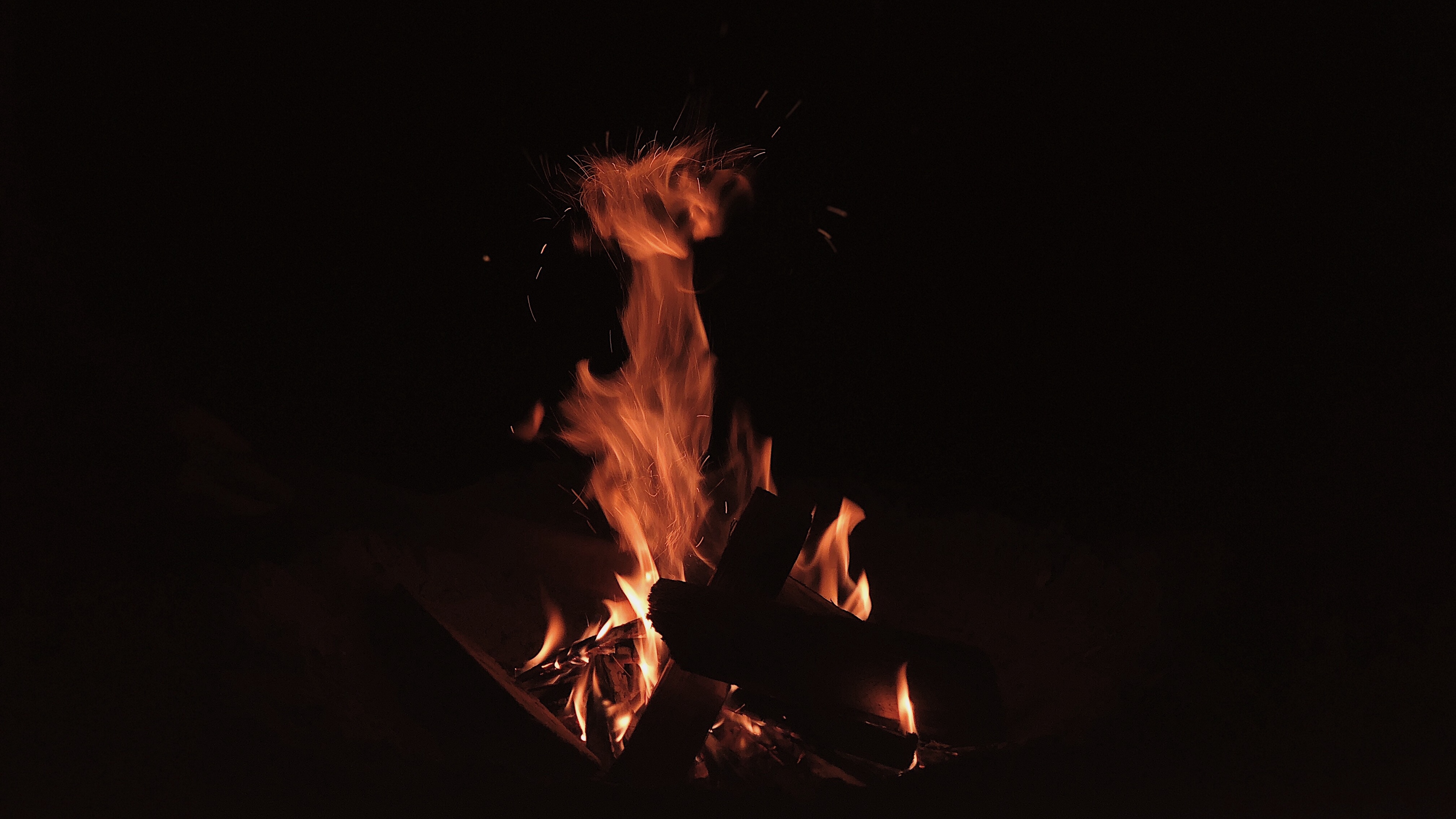 Wallpaper 4k bonfire, fire, flame, sparks, dark, burning 4k Wallpaper