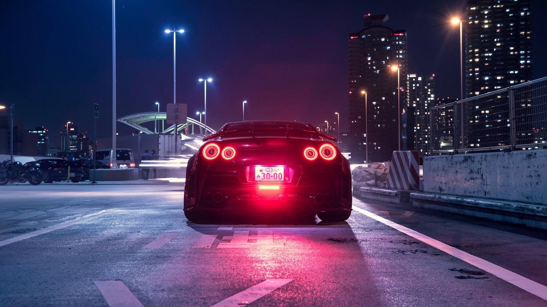 Wallpaper / 1080P, City, JDM, Night, Road, Nissan GT R, Vehicle, Skyscraper, Street Light, Nissan, Rear View, Car, Japanese Cars Free Download