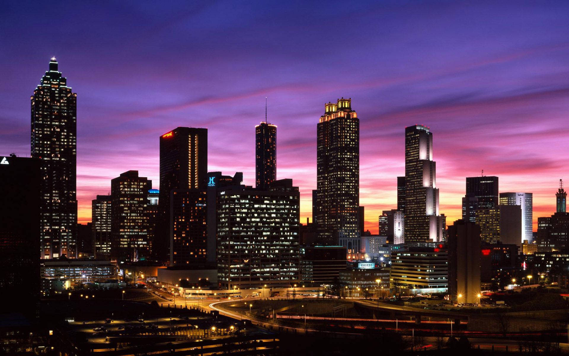 Download Majestic High Rise Buildings Embracing The Atlanta Skyline Wallpaper