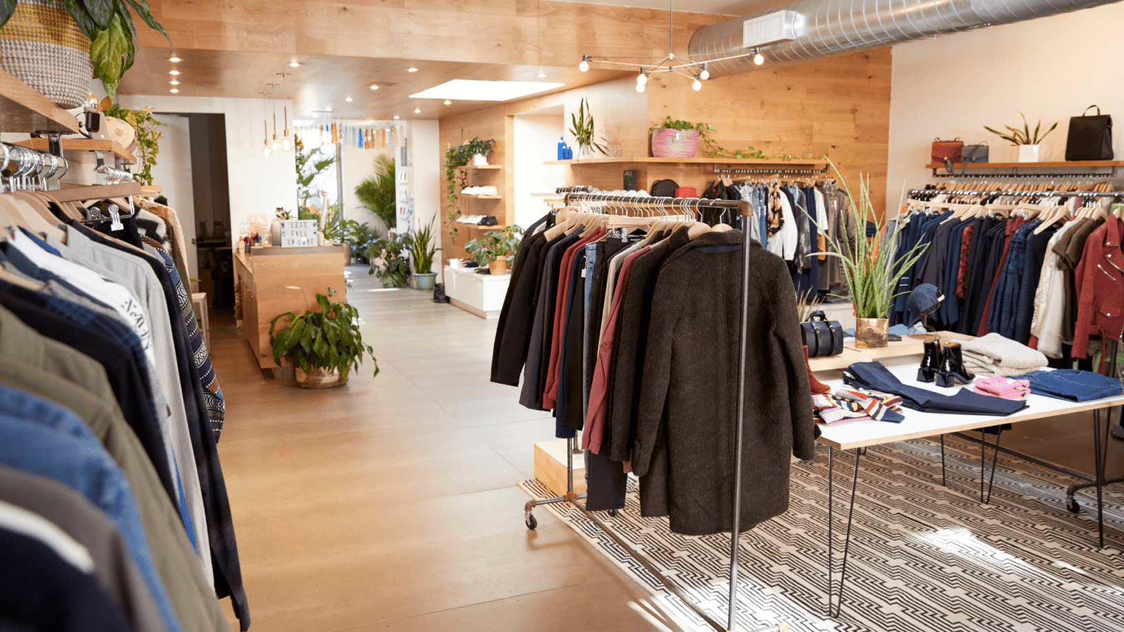 Download A Clothing Store With Clothes On Racks And Plants