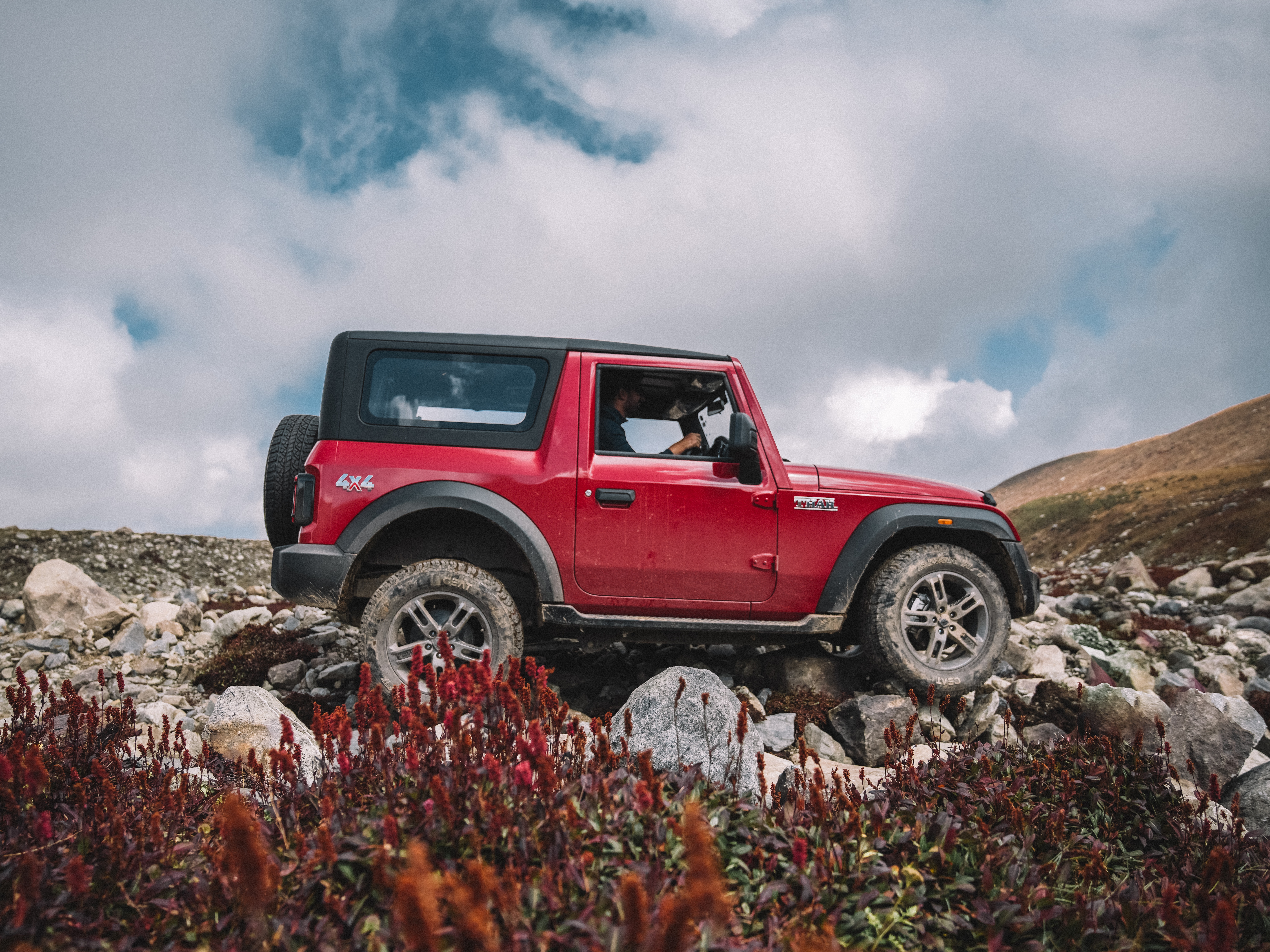 A Red Mahindra Thar on Dirt Road · Free