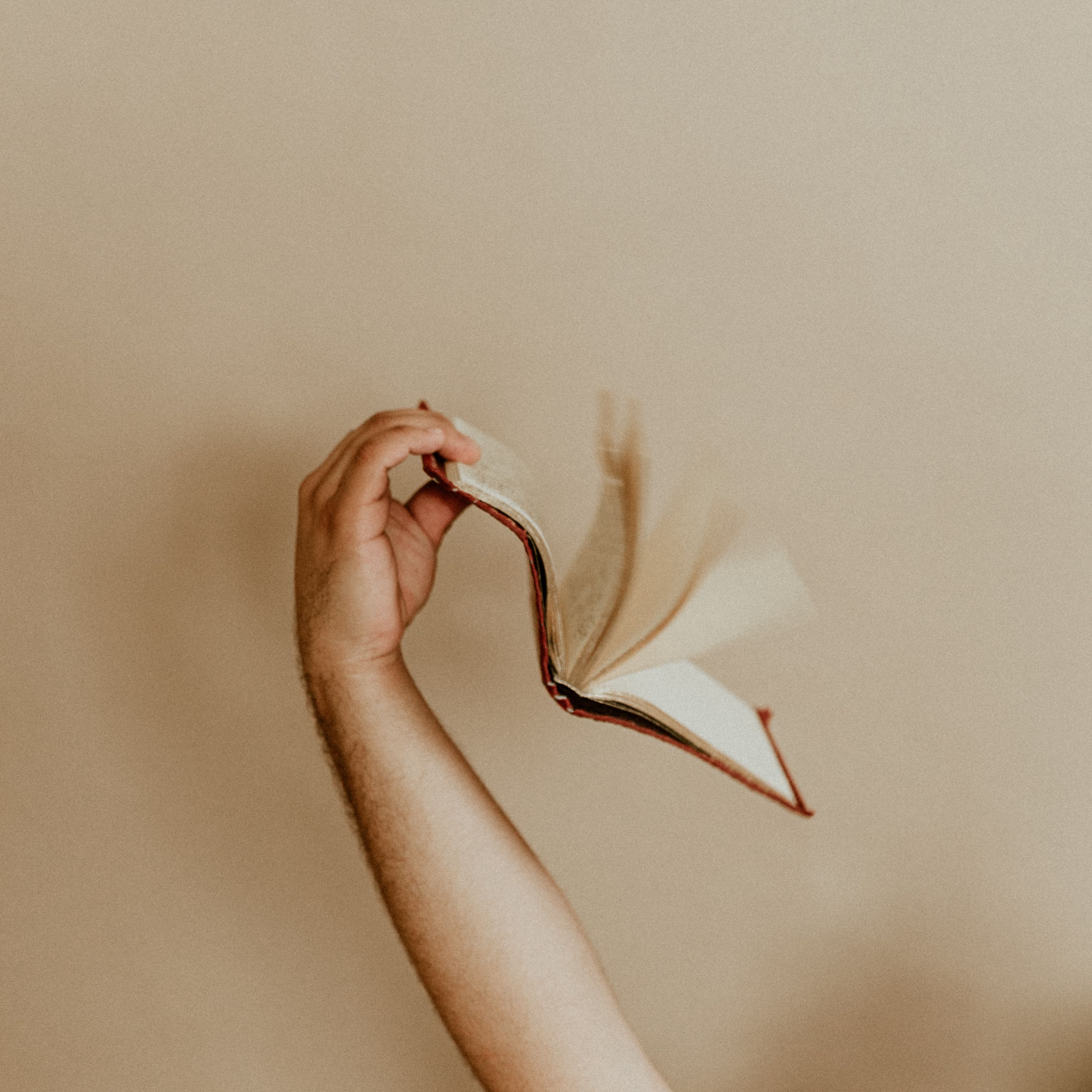 Download wallpaper 3415x3415 book, hand, pages, beige ipad pro 12.9 retina for parallax HD background