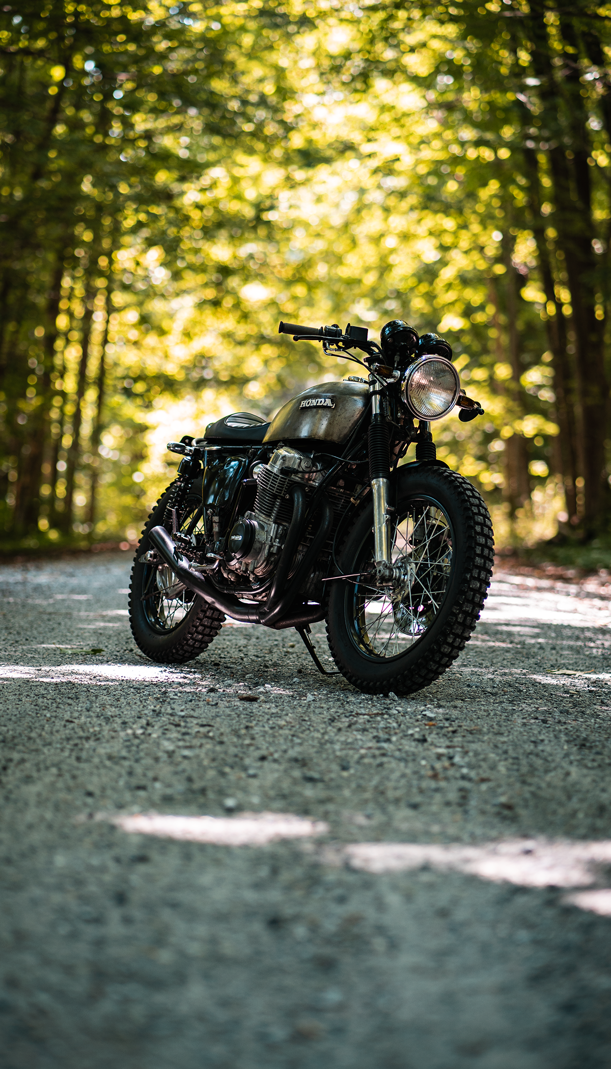 Honda CB750 on dirt road in the woods. Road bike photography, Bike photography, Cafe racer bikes