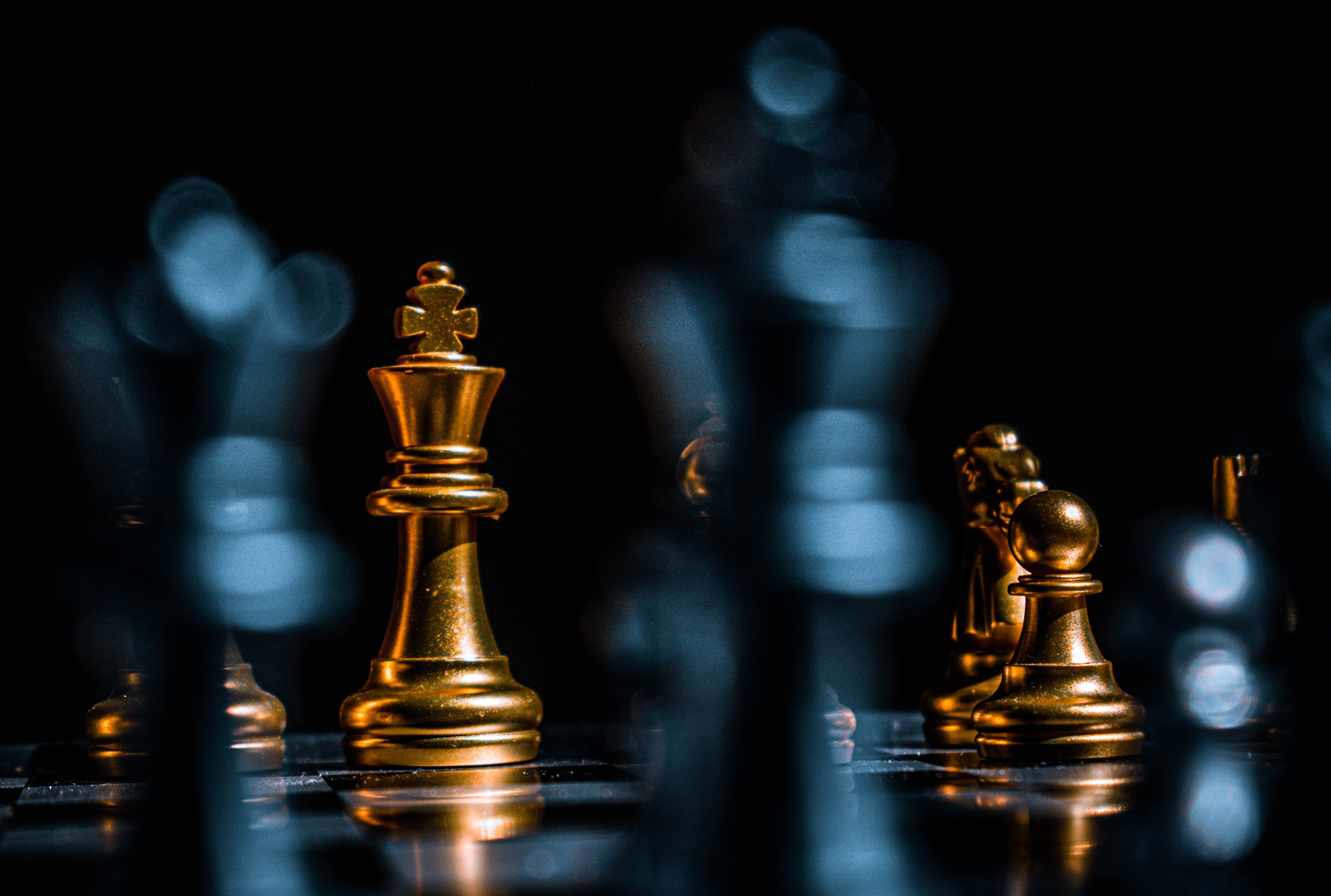 Gold Chess Pieces on Black Surface · Free
