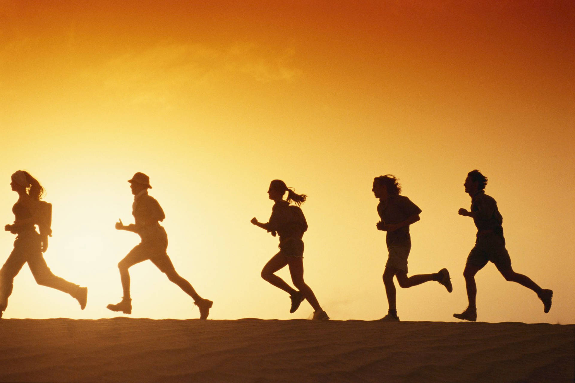 Download Running People Against Sunset Wallpaper