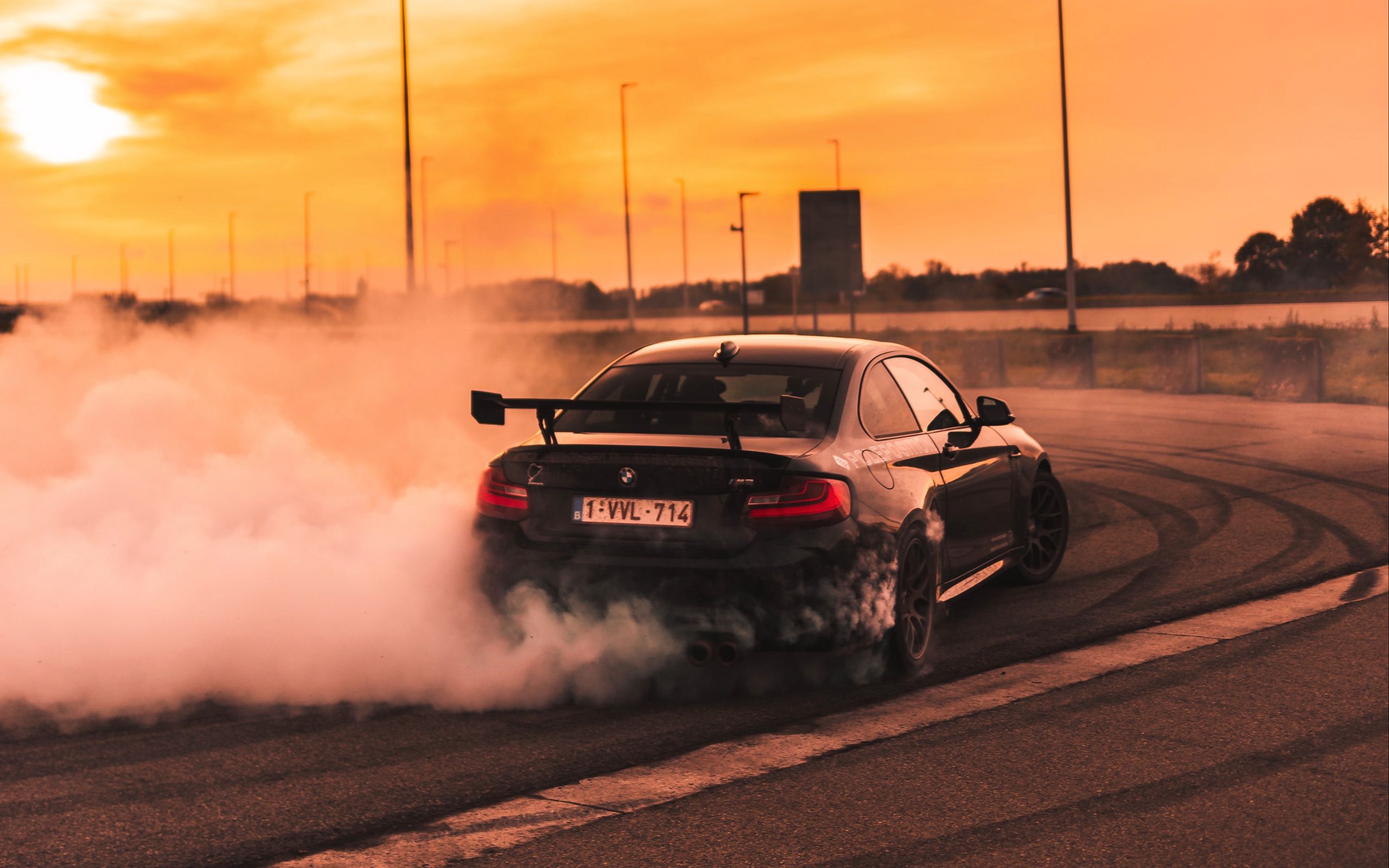 Download wallpaper 2560x1600 bmw, speed, drift, smoke, sunset widescreen 16:10 HD background
