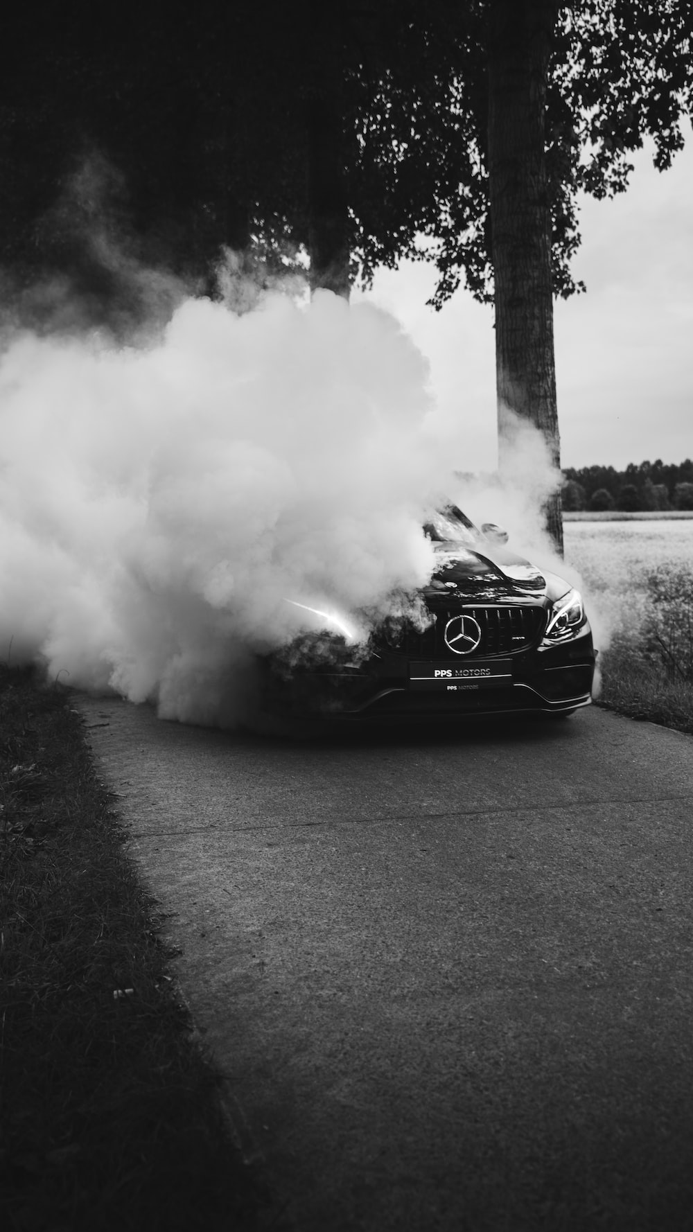 Mercedes Benz On Road Covered With Smoke During Daytime Photo