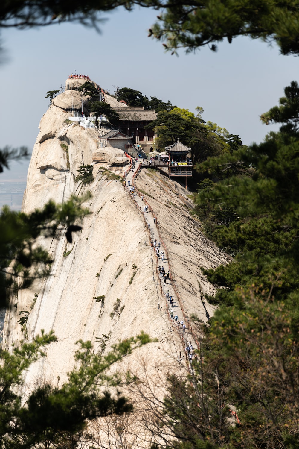 People walking on brown rocky mountain during daytime photo