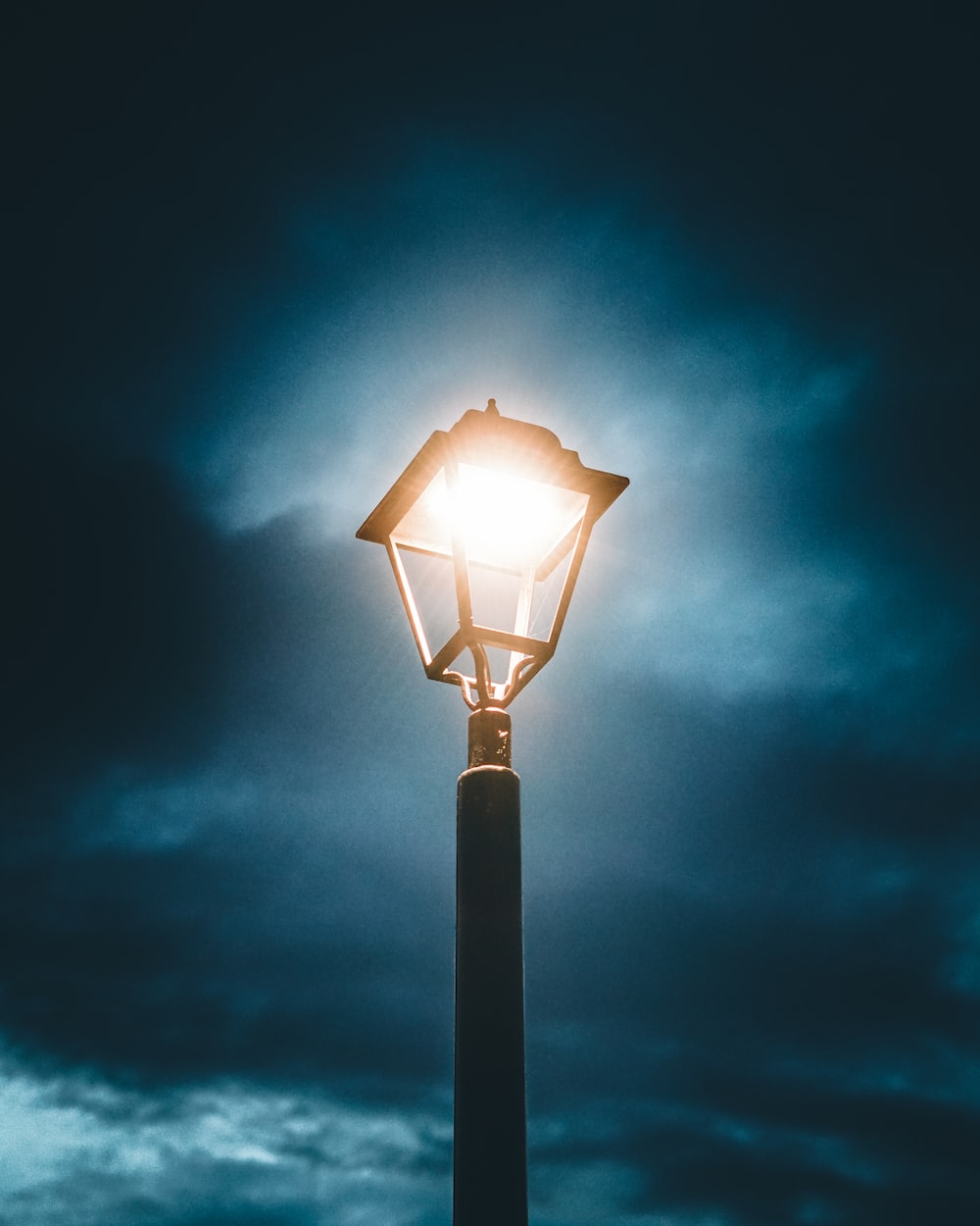 Black street light under blue sky photo