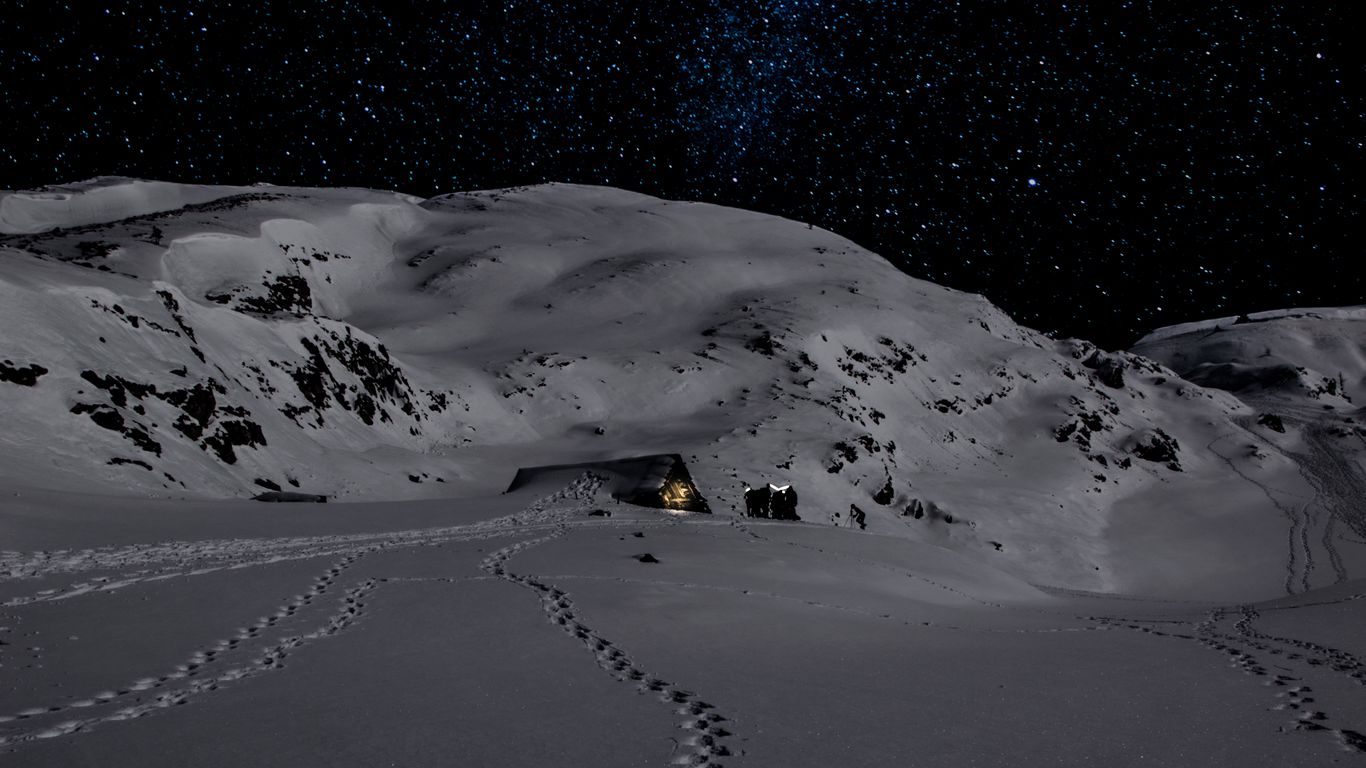 Download wallpaper 1366x768 night, snow, mountains, footprints, winter tablet, laptop HD background