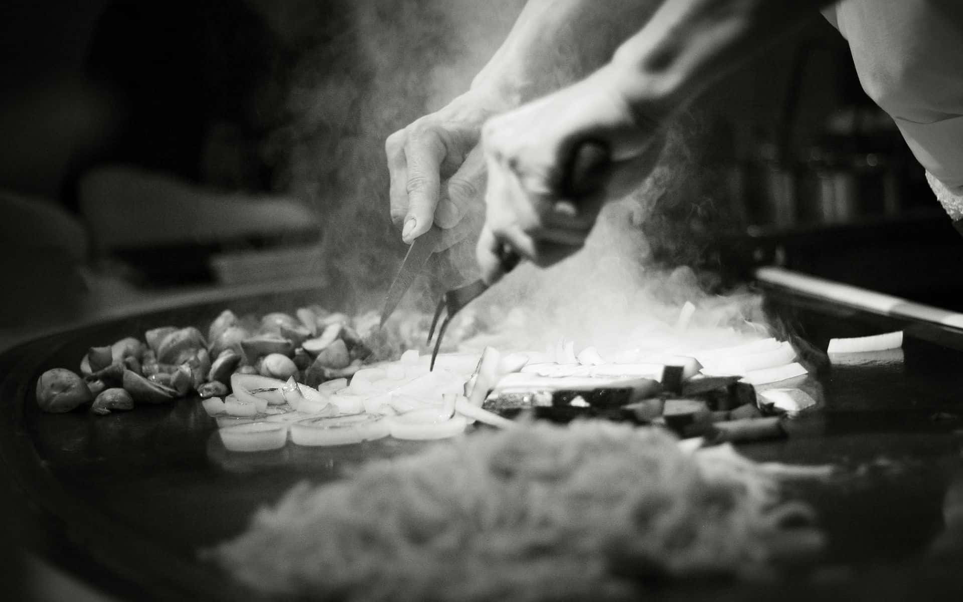 Chef Is Preparing Food On A Grill
