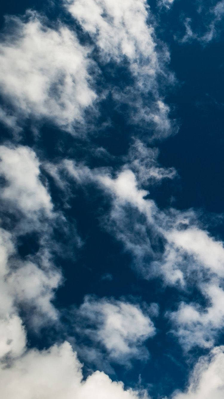 Download A cloudy sky from the heights of iPhone Wallpaper