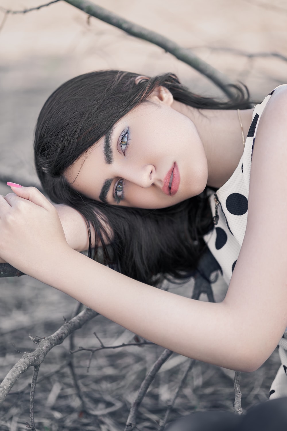 Woman Wearing White And Black Polka Dot Sleeveless Top Photo