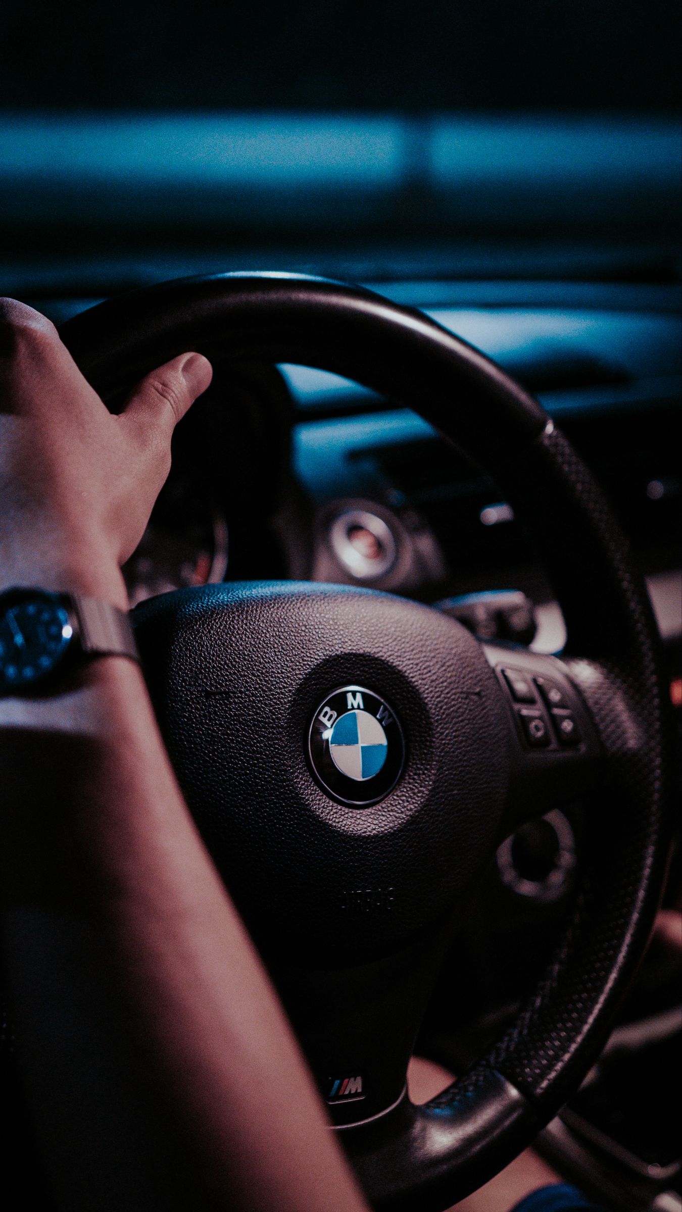 Download wallpaper 1350x2400 bmw, steering wheel, hand, interior, watches iphone 8+/7+/6s+/for parallax HD background