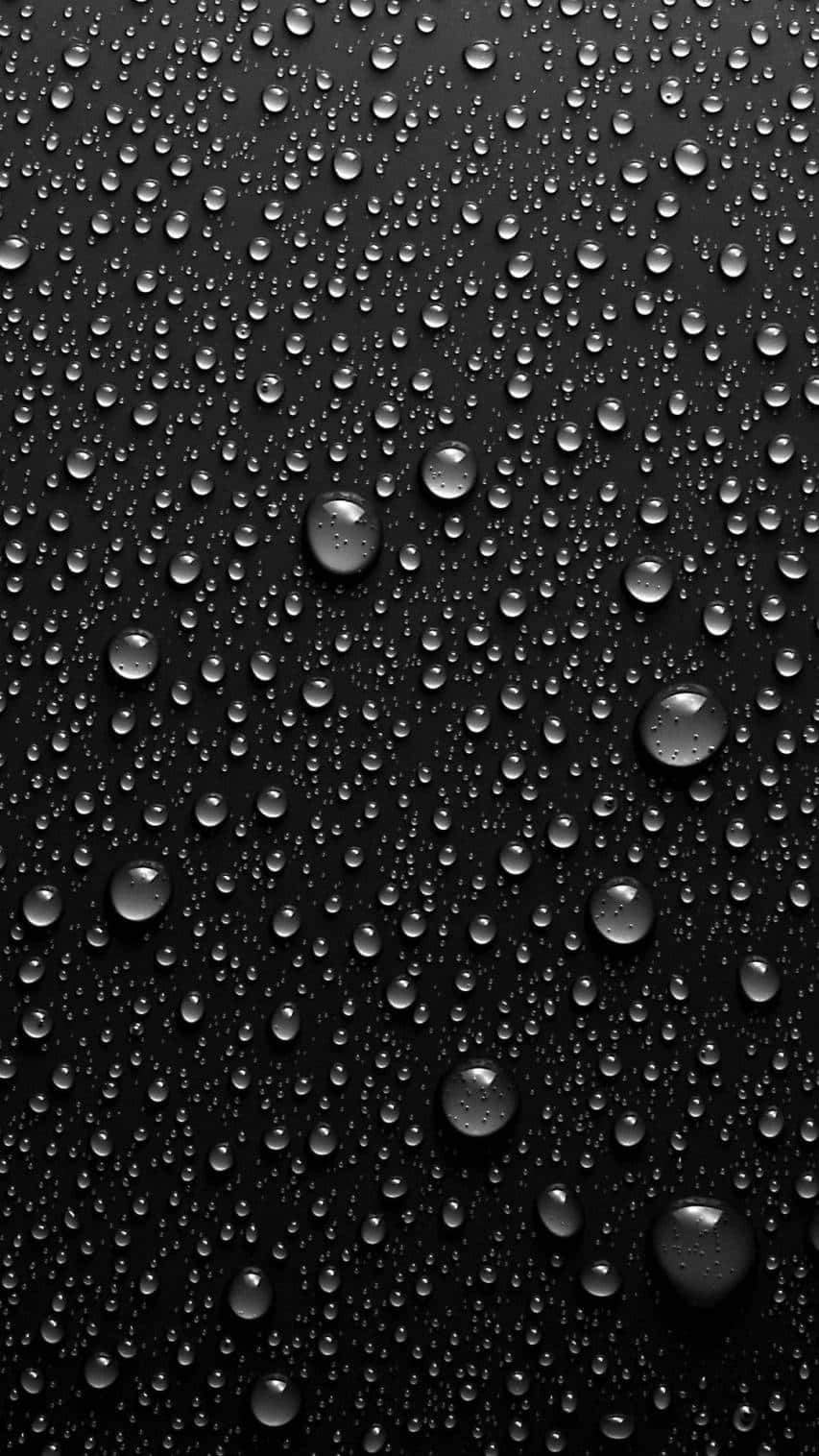Download Water Drops On A Black Background Wallpaper