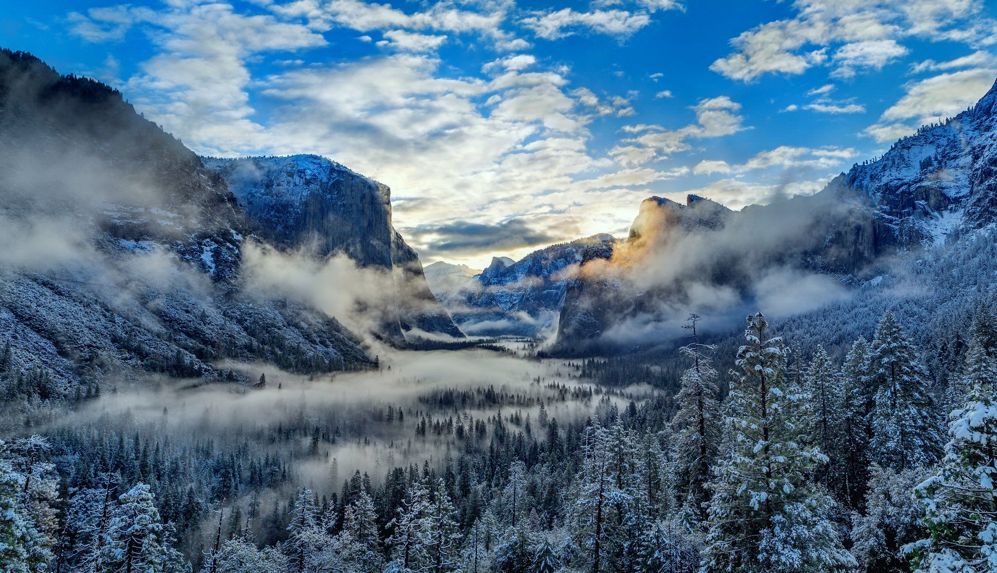 Fog and Clouds over Snowy Winter Mountain