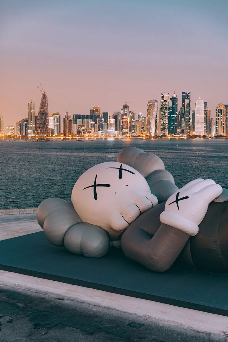 KAWS debuts inflatable sculpture on doha's dhow harbor overlooking the city skyline. Kaws wallpaper, Bape wallpaper, Hypebeast iphone wallpaper