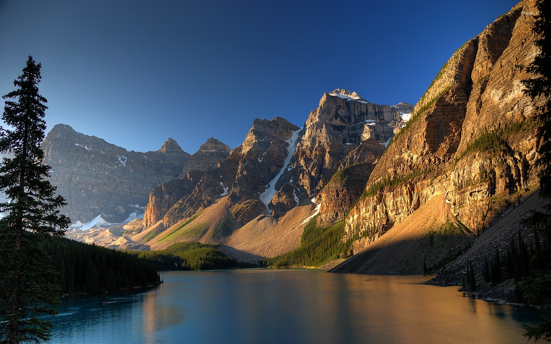 Sun warming up the rocky mountain peaks by the river wallpaper wallpaper