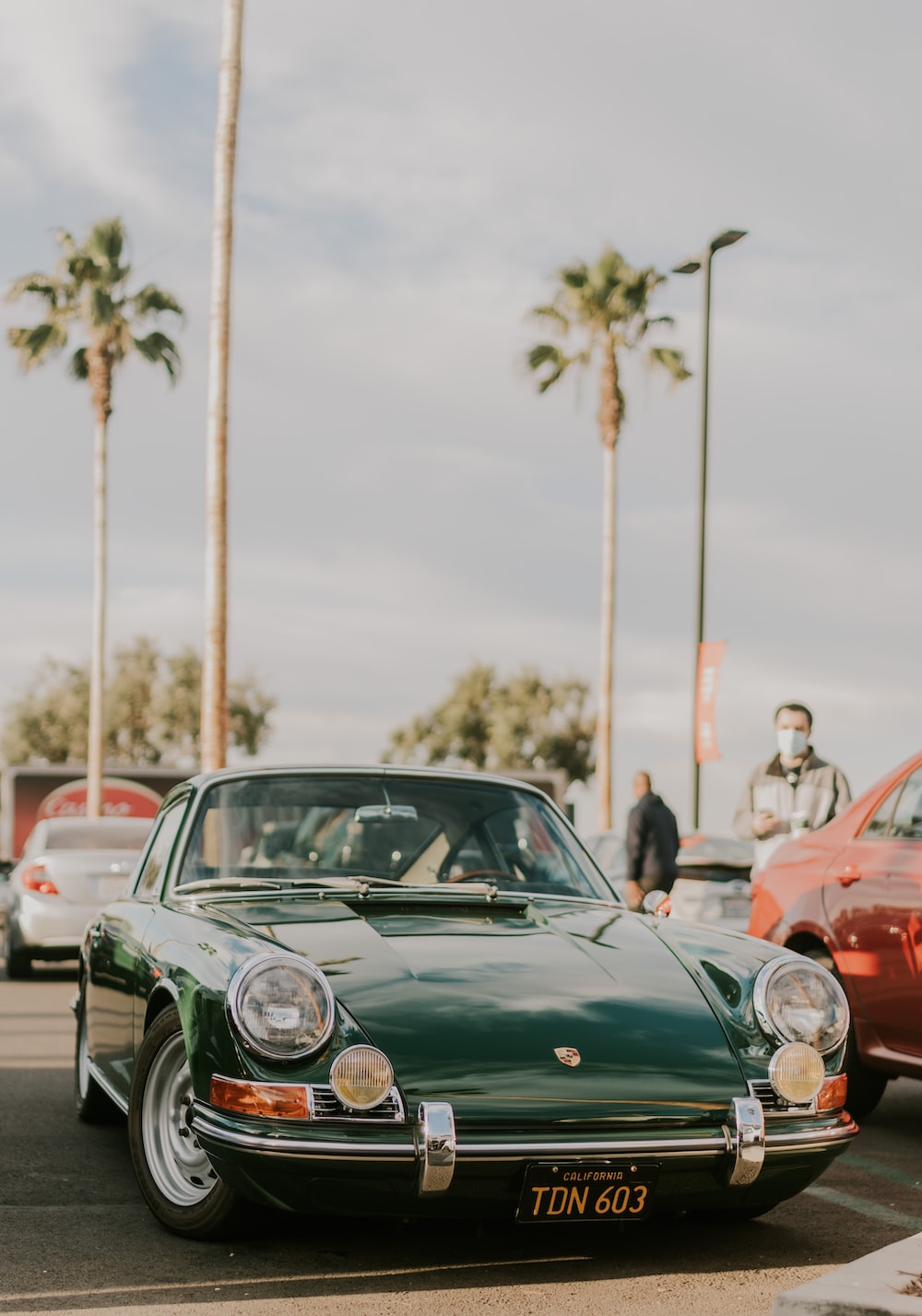 Green porsche 911 parked on street during daytime photo