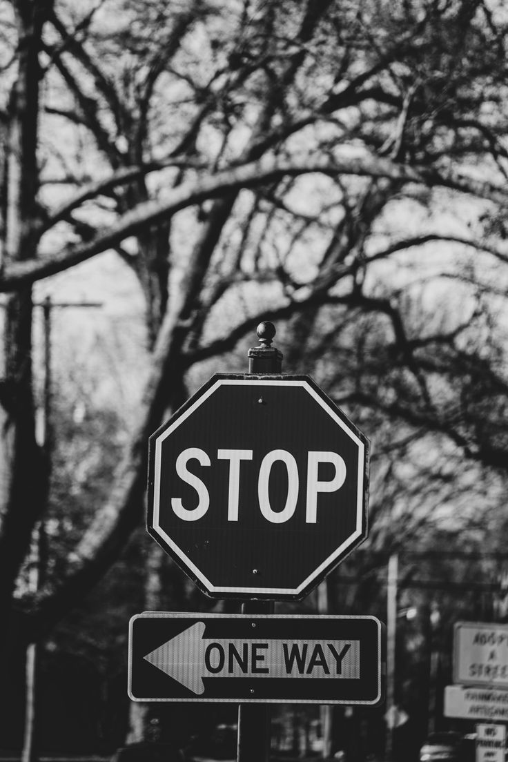 Stop sign, street signs, black and white