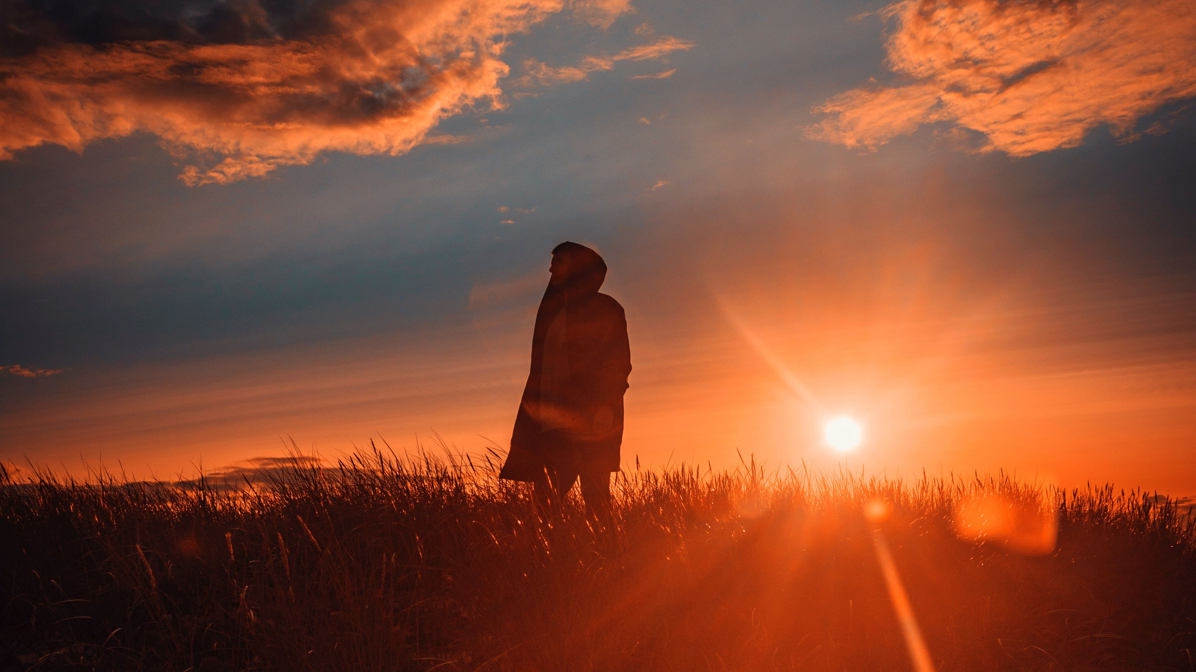 Download wallpaper 3840x2160 man, alone, sunset, grass, field, sunlight 4k uhd 16:9 HD background