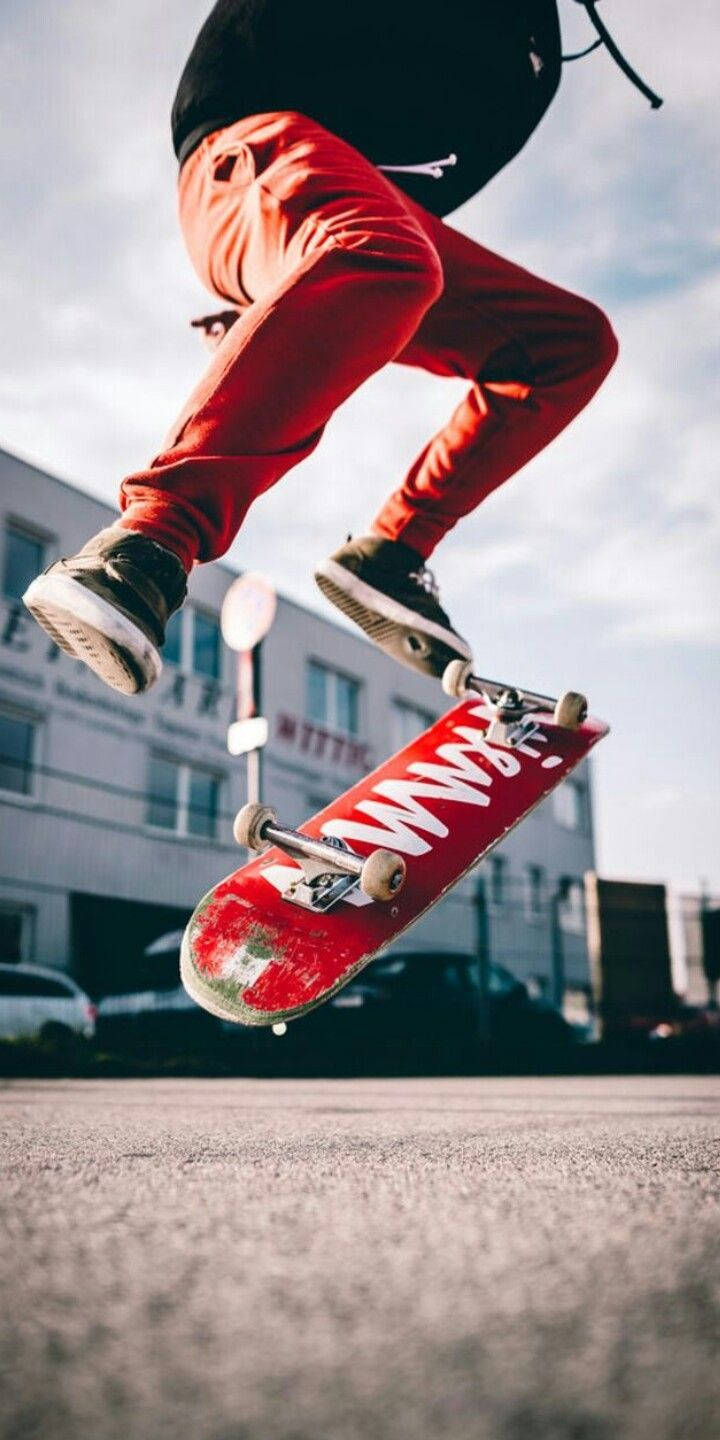 Download Skater With Red Skateboard iPhone Wallpaper