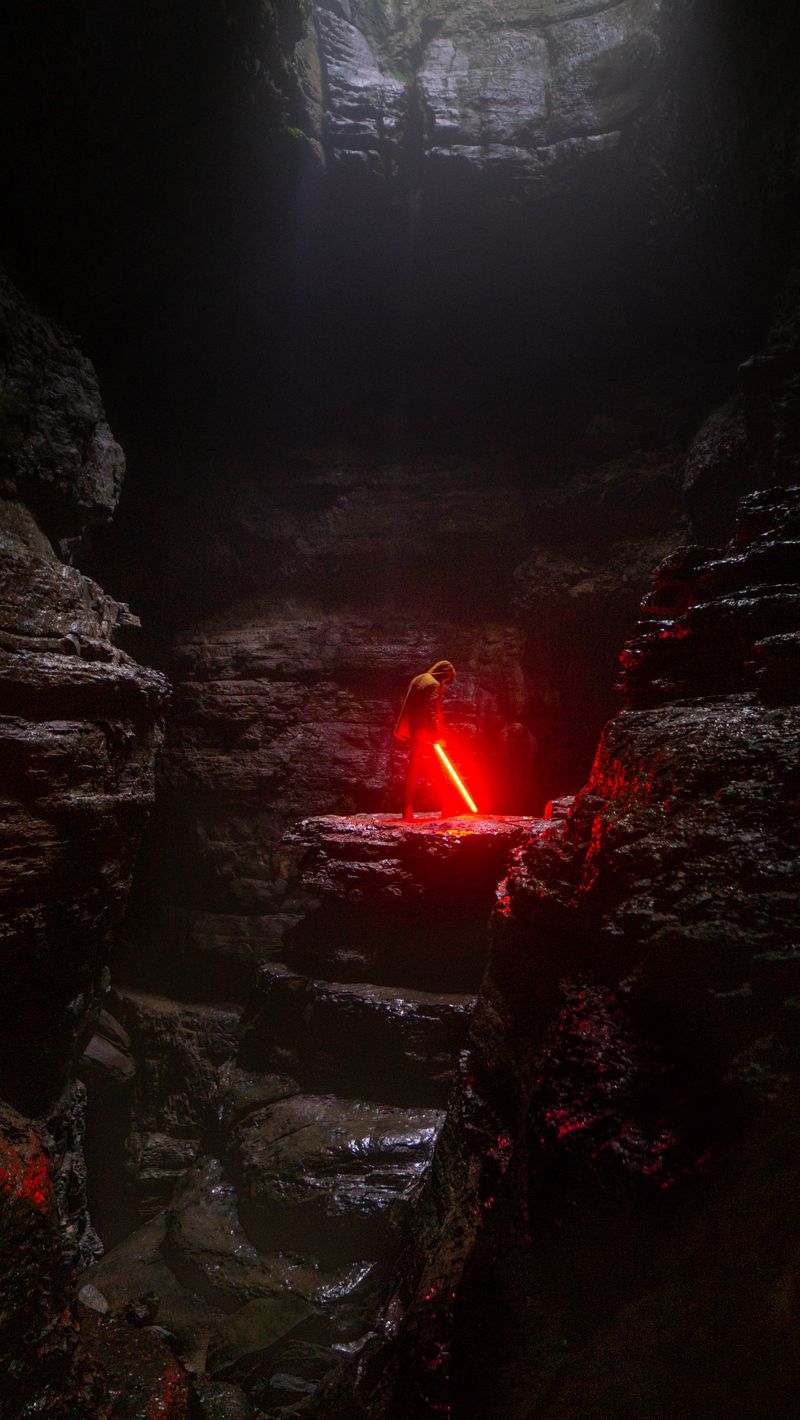 Download Wallpaper 800x1420 Cave, Man, Lightsaber, Light Iphone Se 5s 5c 5 For Parallax HD Background