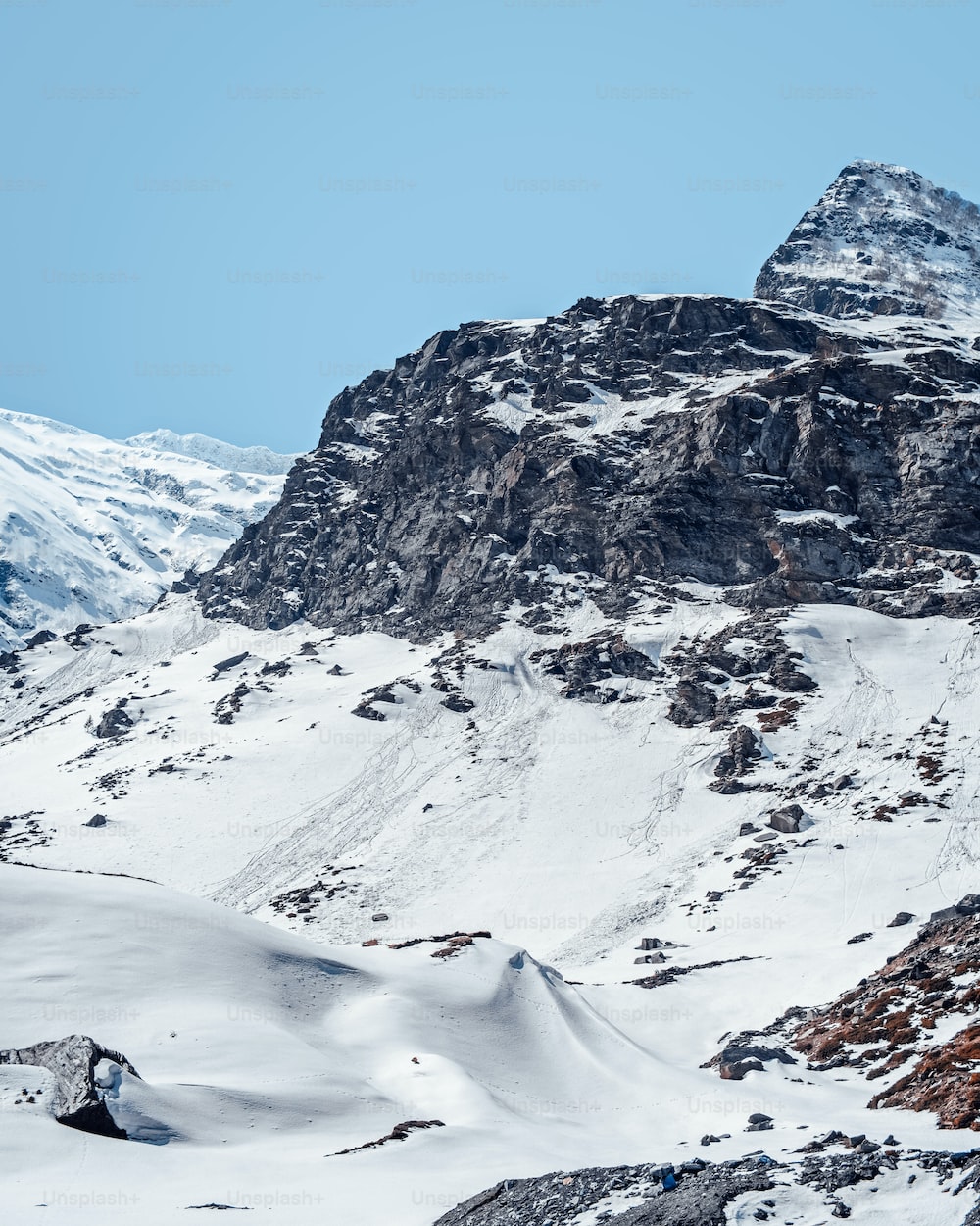 A snow covered mountain with a sky background photo