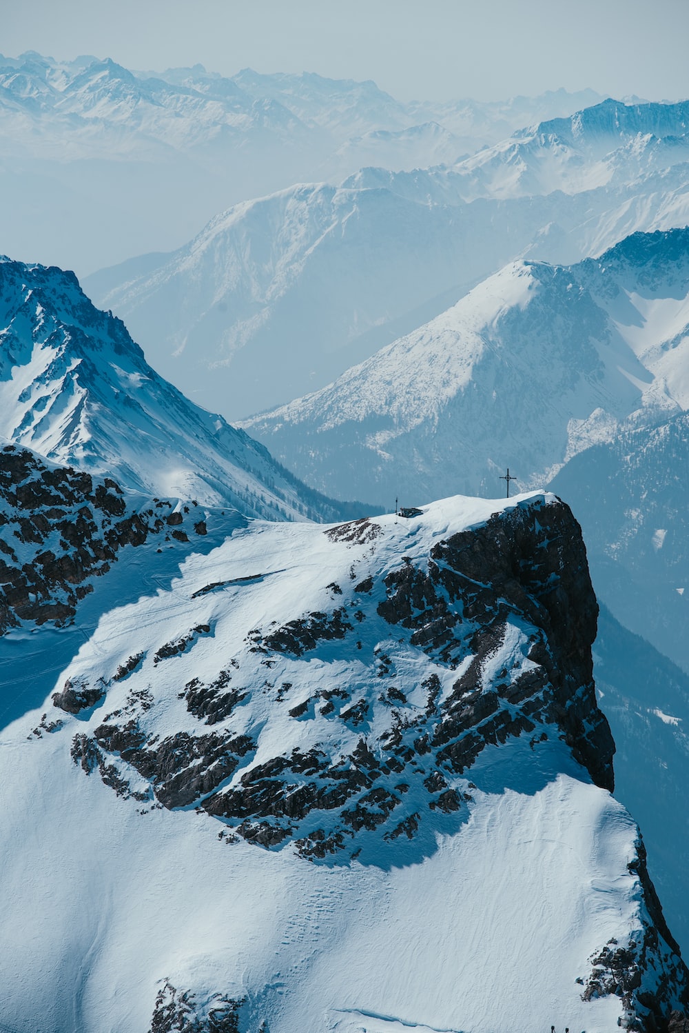 A view of a mountain range covered in snow photo