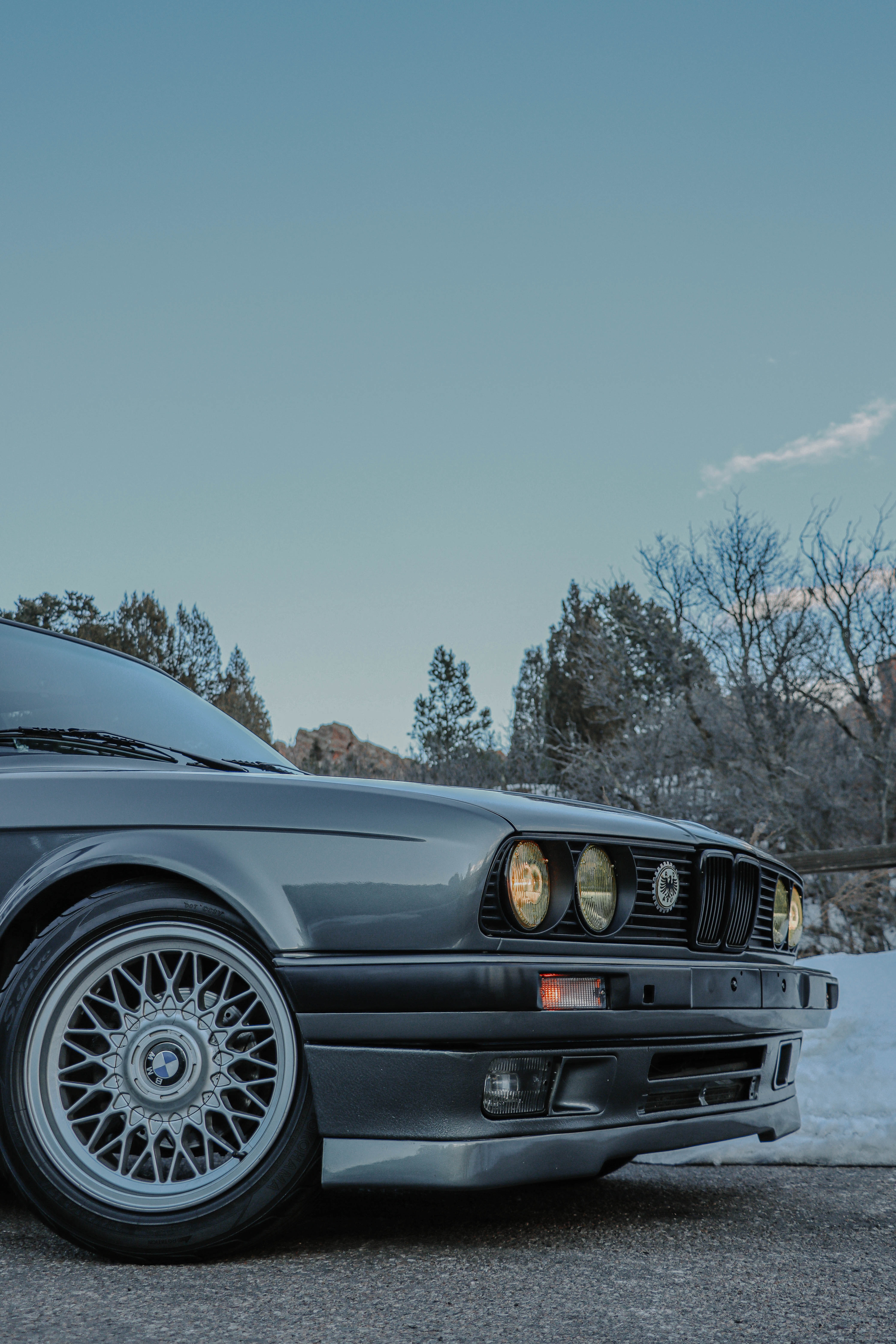 Parked BMW E30 on Pavement near Pile of Snow · Free
