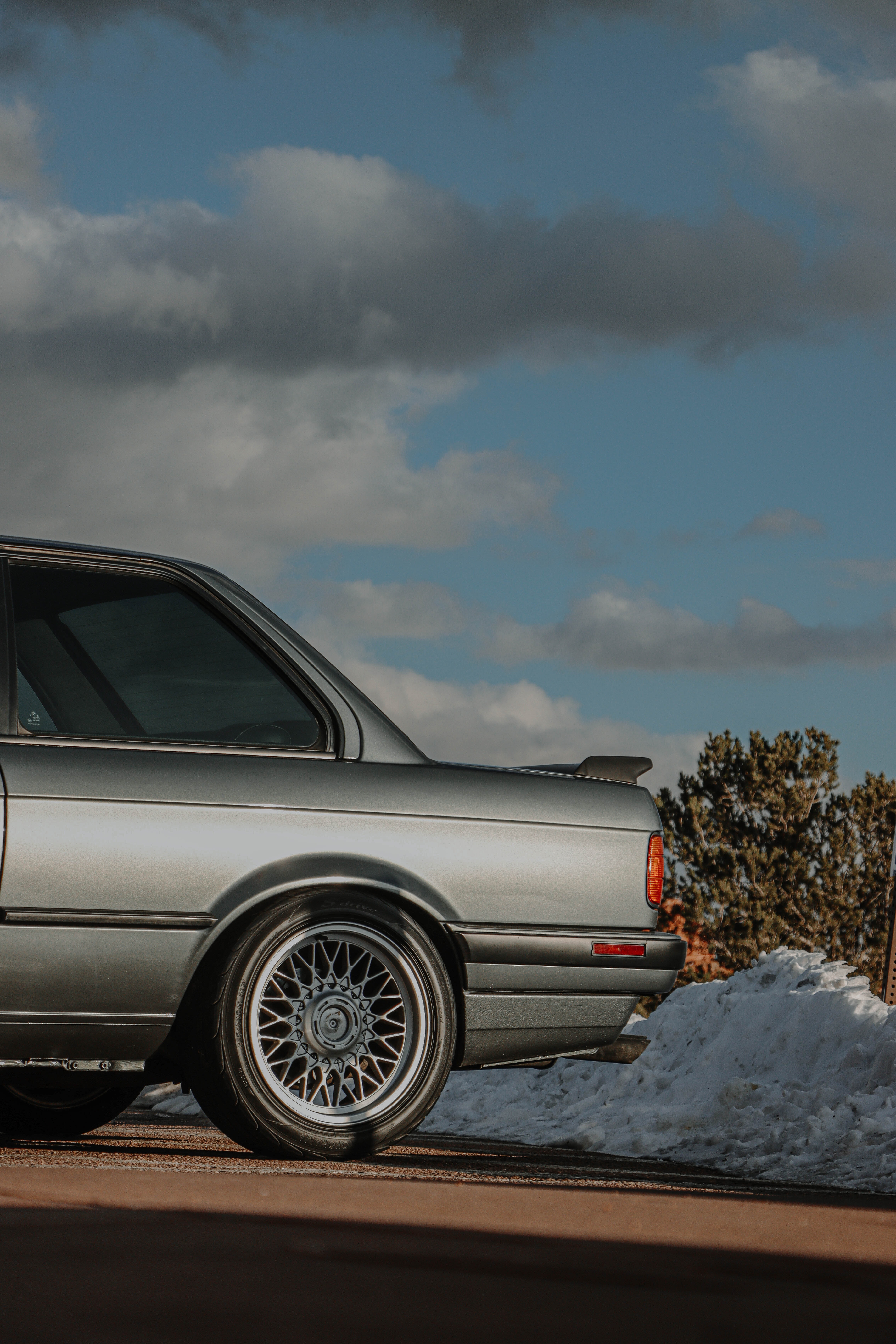 Parked BMW E30 on Pavement near Pile of Snow · Free