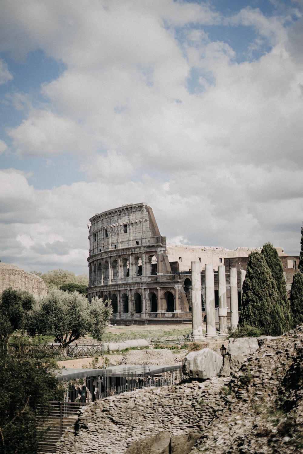 People standing near Colosseum in Rome, Italy under white and blue skies during daytime photo