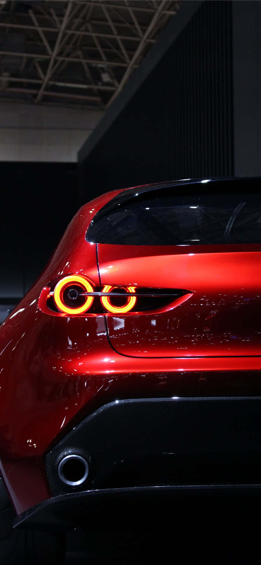 Download A Red Sports Car With A Red Tail Light Wallpaper