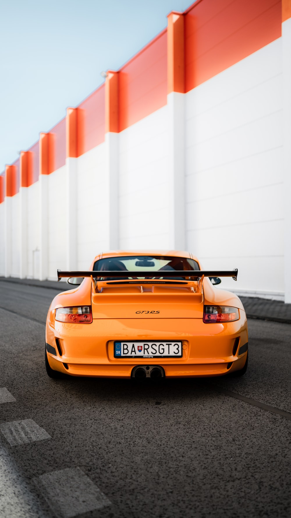 Orange porsche 911 on road during daytime photo