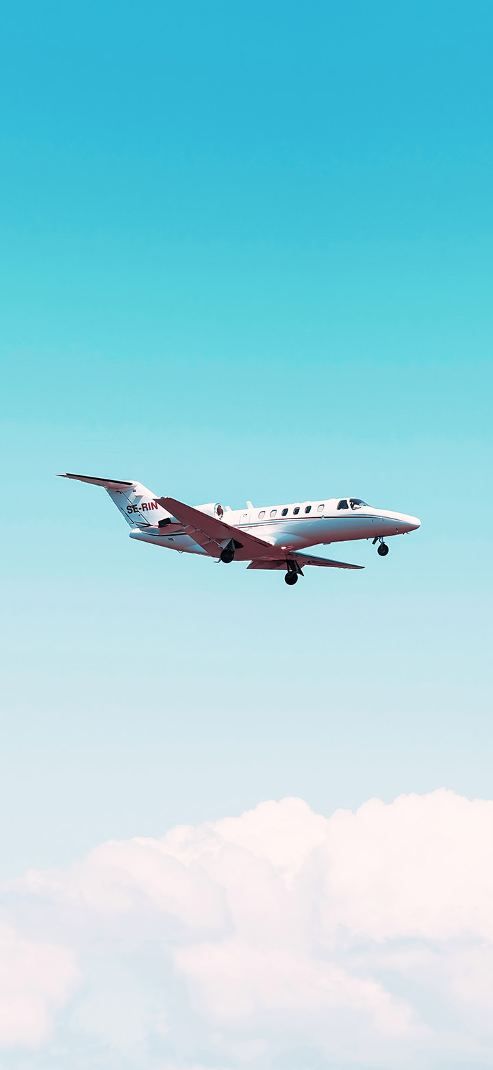 White Airplane Flying Above The Clouds