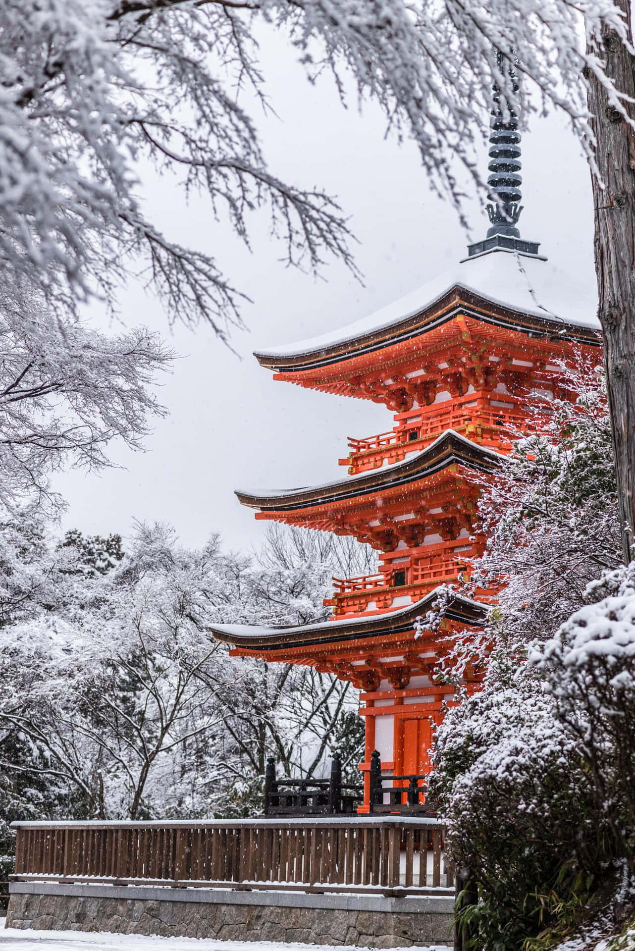 Download A Pagoda In The Snow With Trees Surrounding It Wallpaper