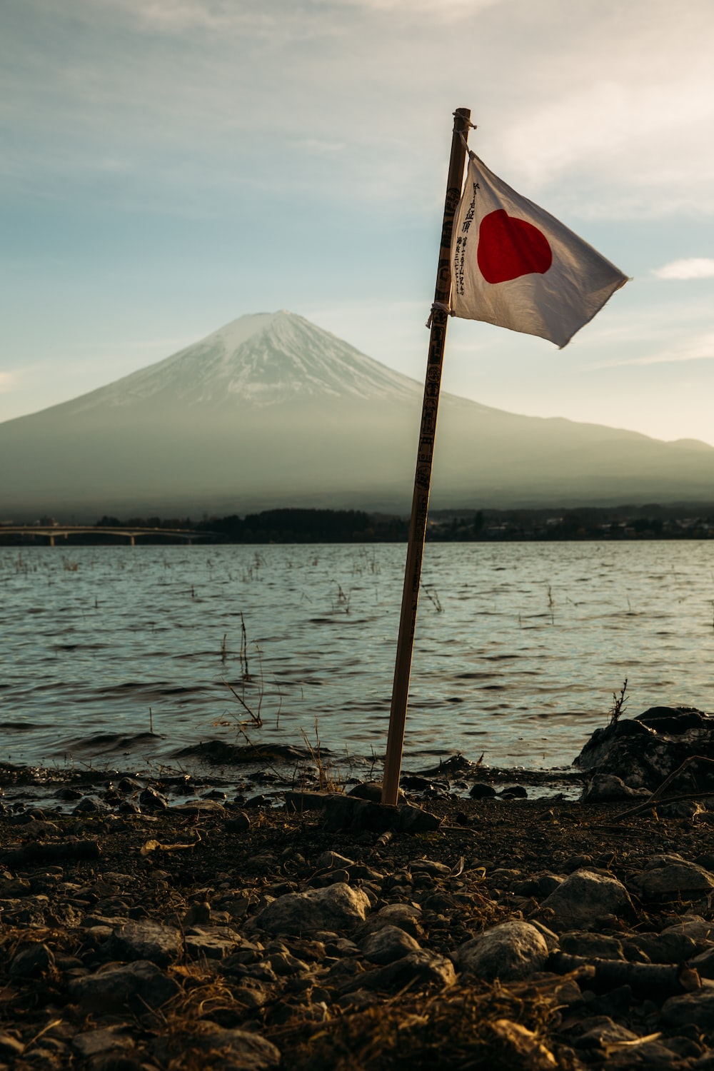 Japan flag mounted near on body of water photo