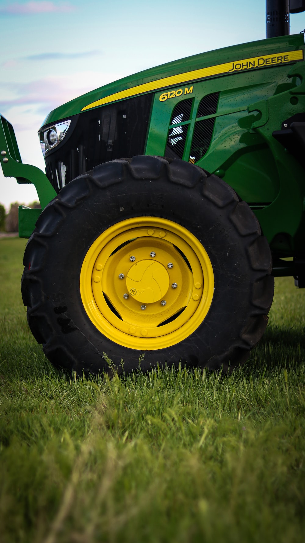 A tractor is parked in the grass on a sunny day photo