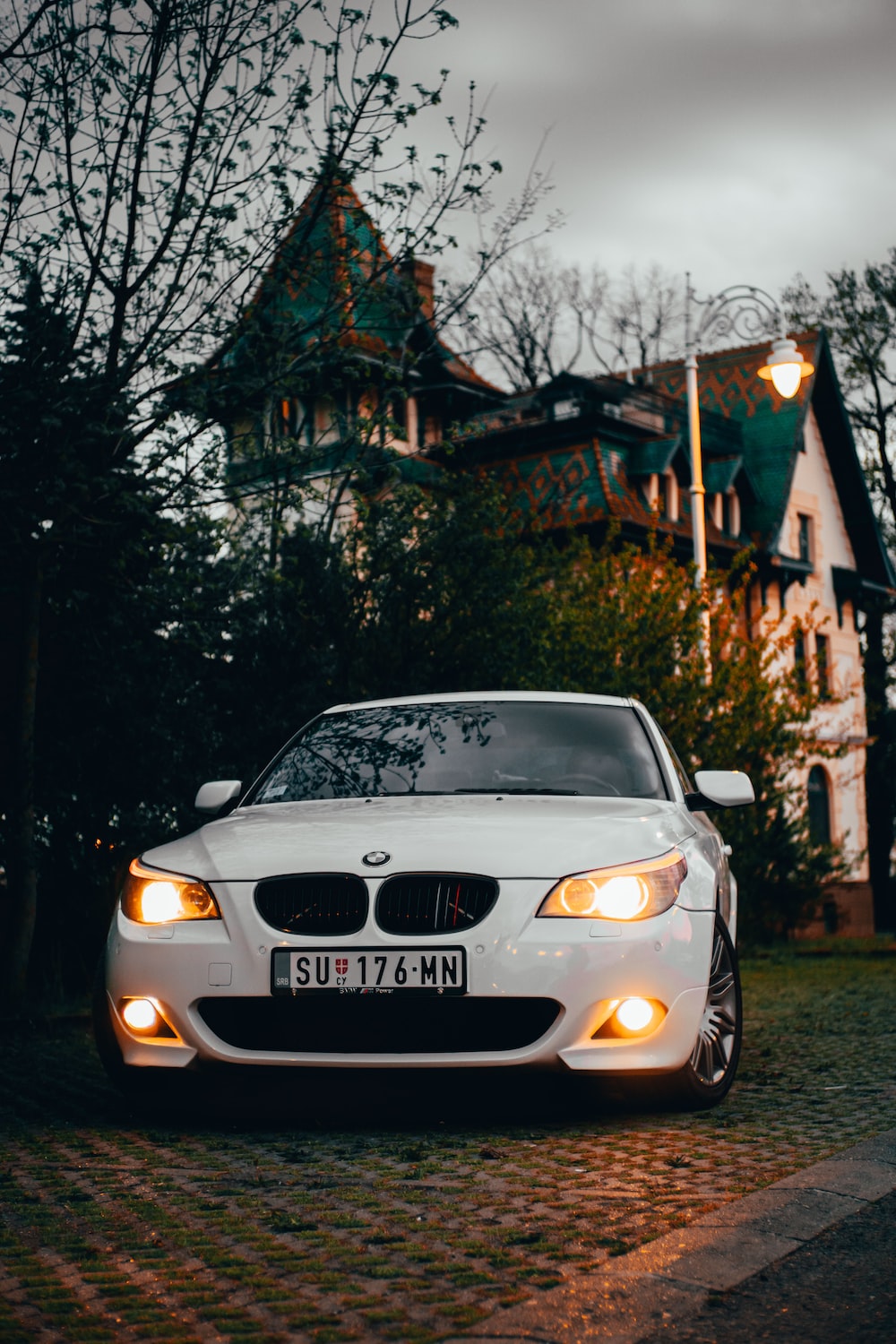 A white car parked in front of a house photo