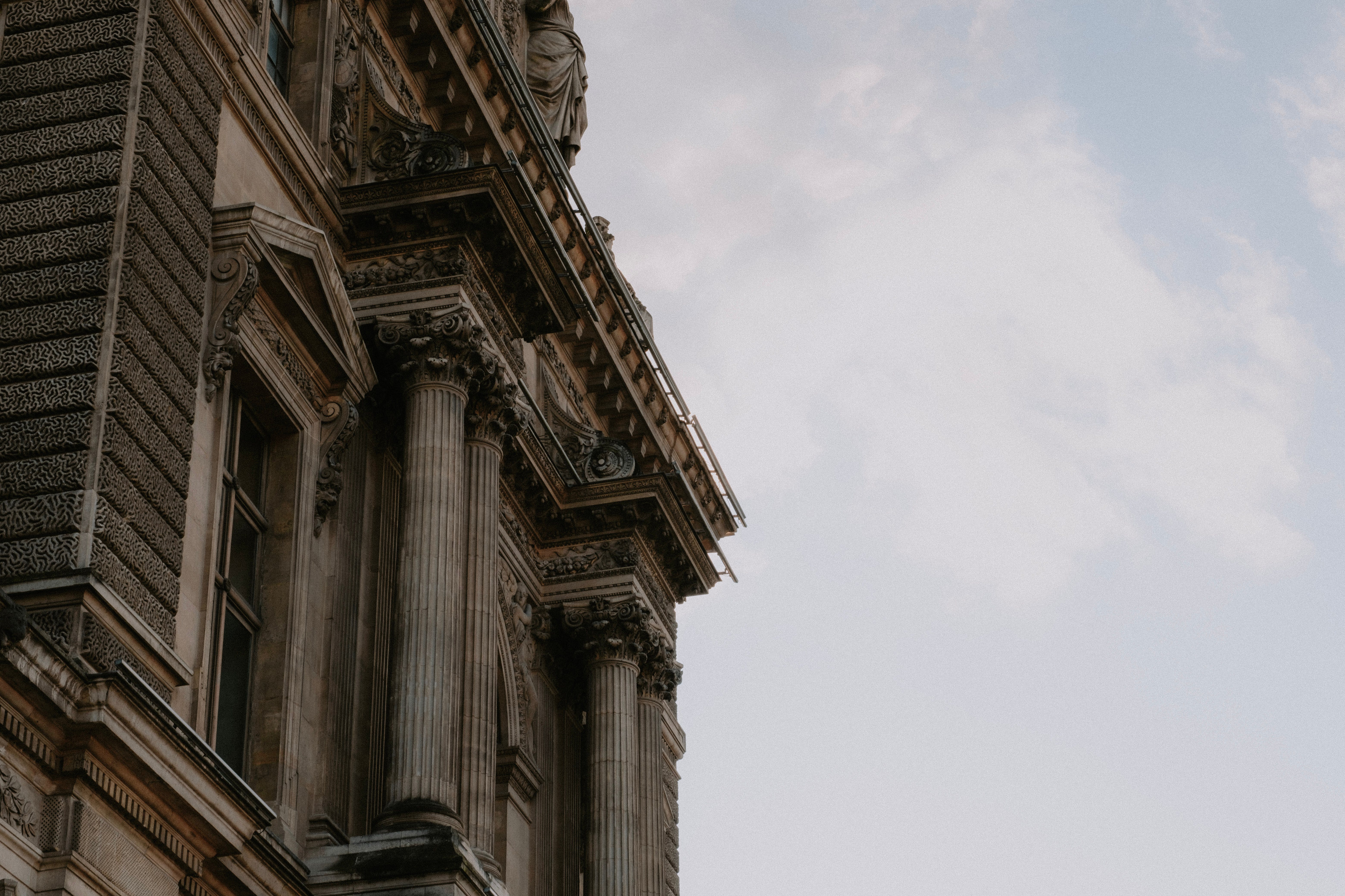 A Building with Pillars under a Cloudy Sky · Free