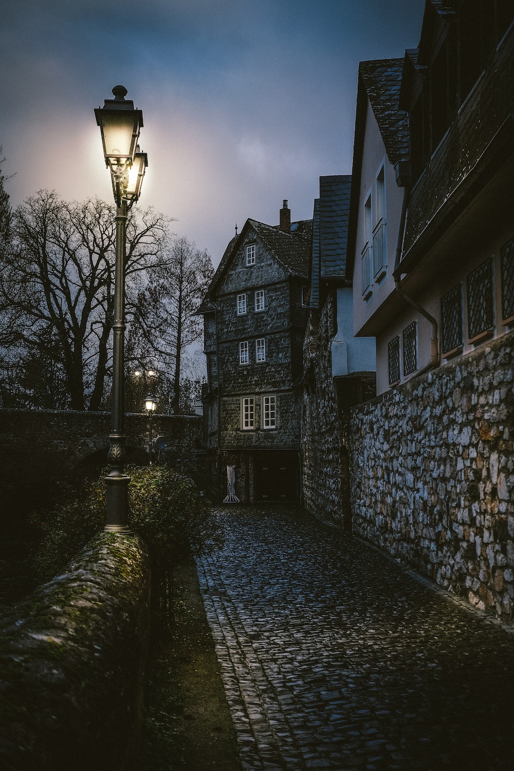 Gray outdoor lights besides stone pathwaysw photo